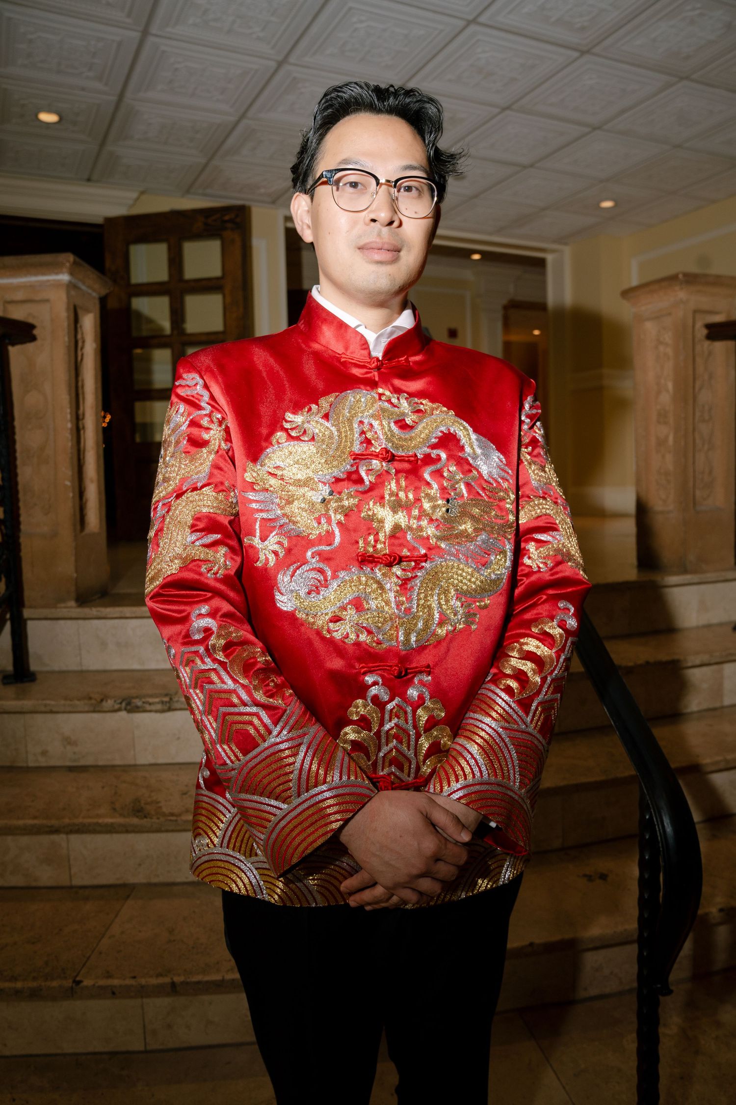 A traditional red Chinese wedding jacket with intricate gold dragon embroidery.