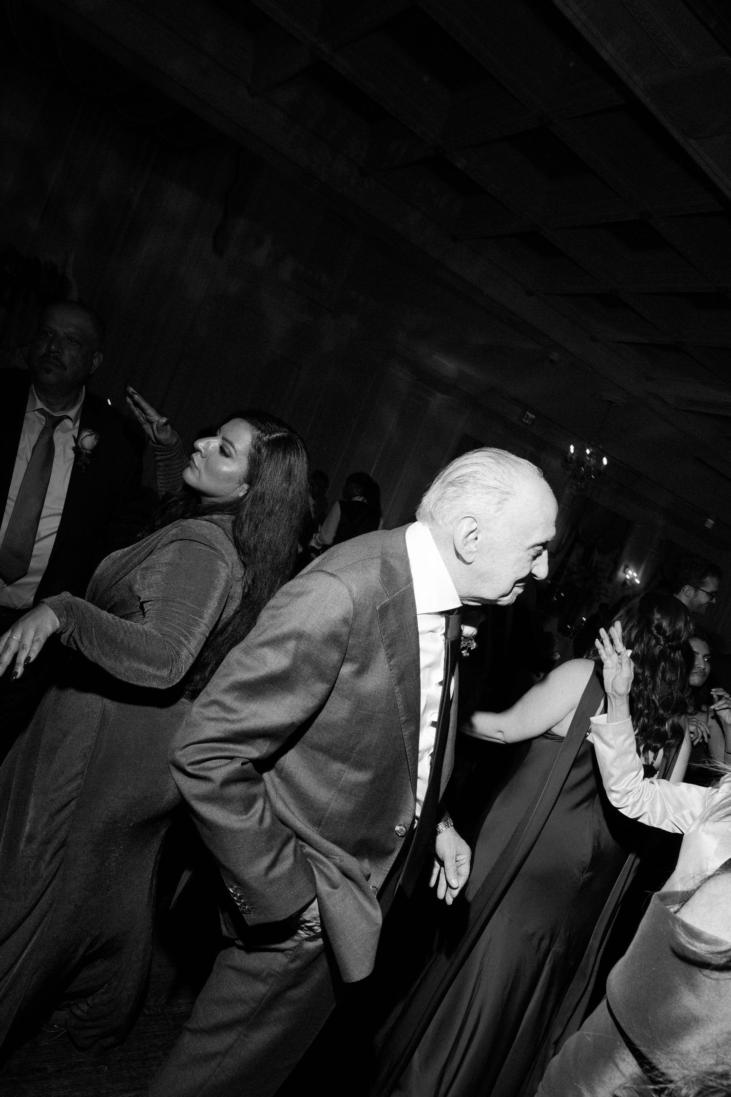 Black and white dance sequence showing couples swaying together at a wedding reception.