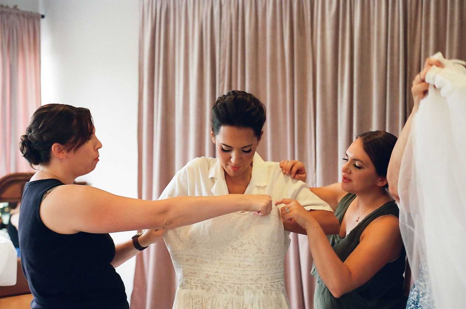 Collage of wedding preparation moments showing a bride getting ready with help from bridesmaids in a sunlit room.