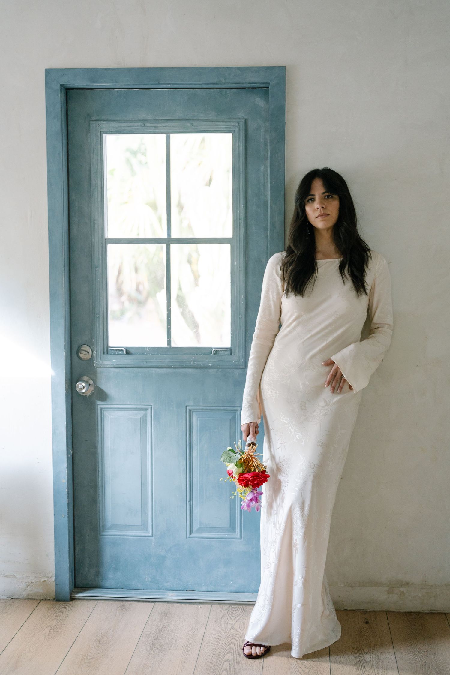Series of photos showing a person in a white dress posing against a wall with a blue door.