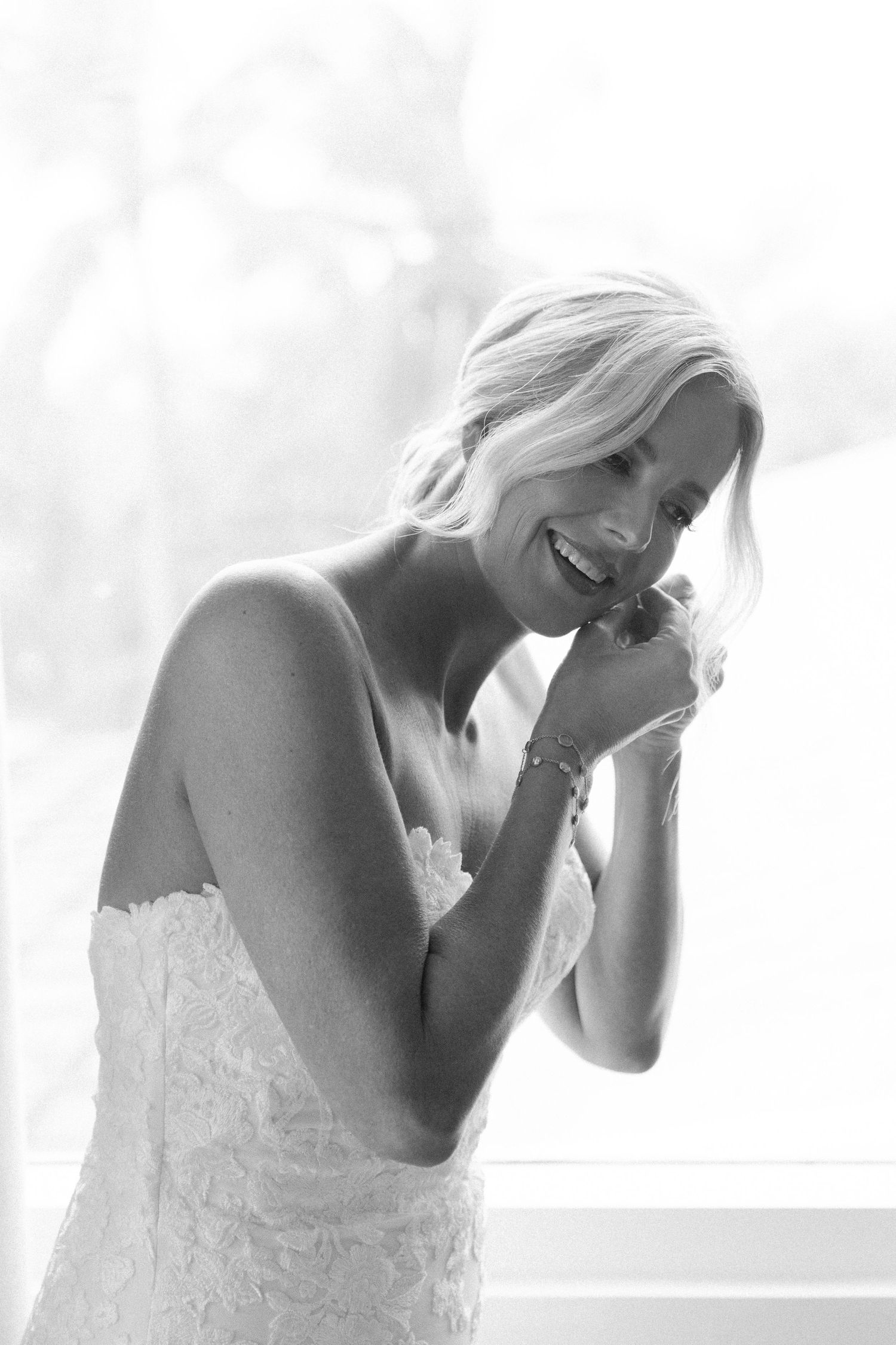 Artistic black and white photo showing emotional moments during wedding preparations.