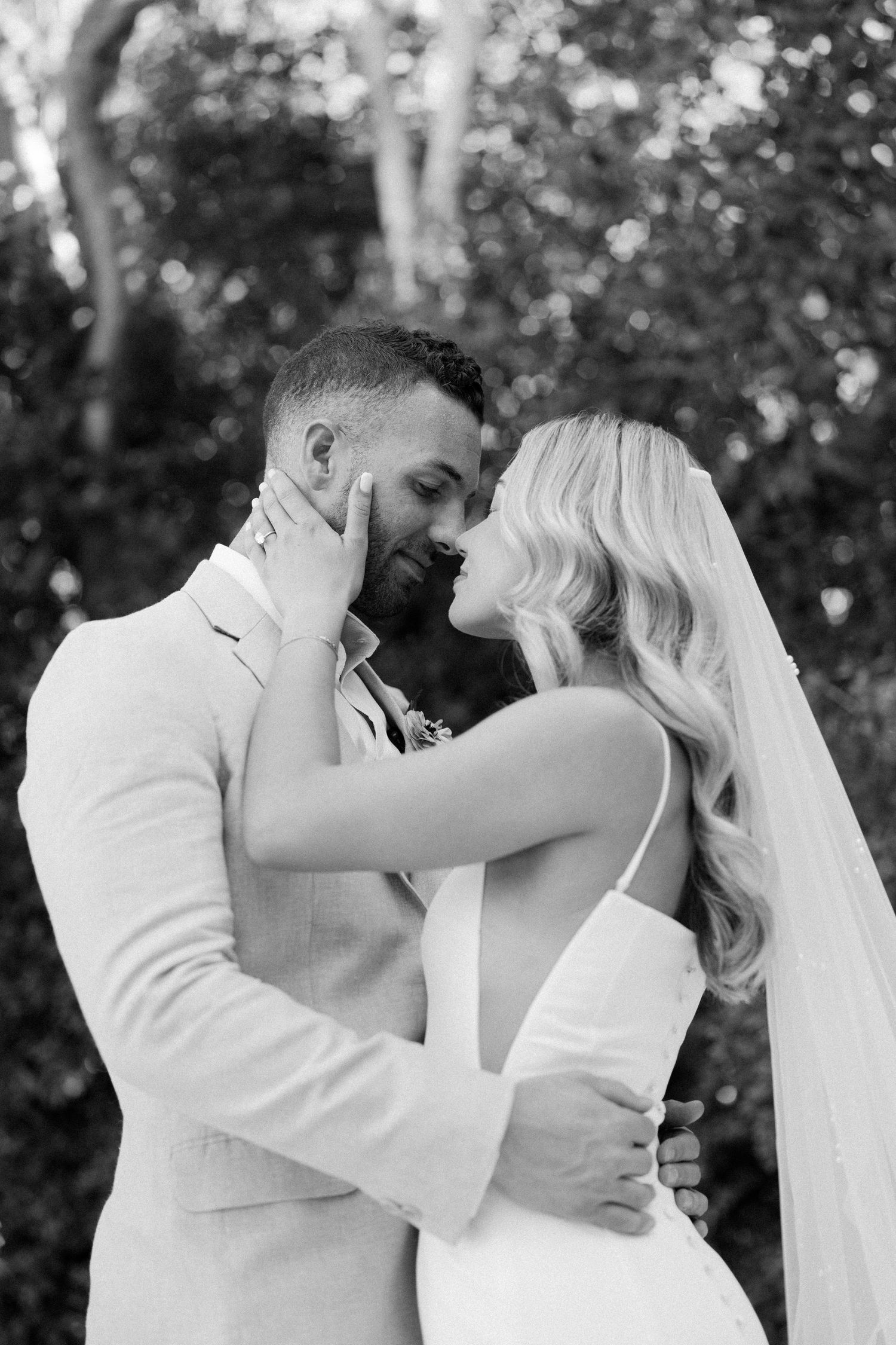 Romantic black and white wedding portrait showing an intimate moment.