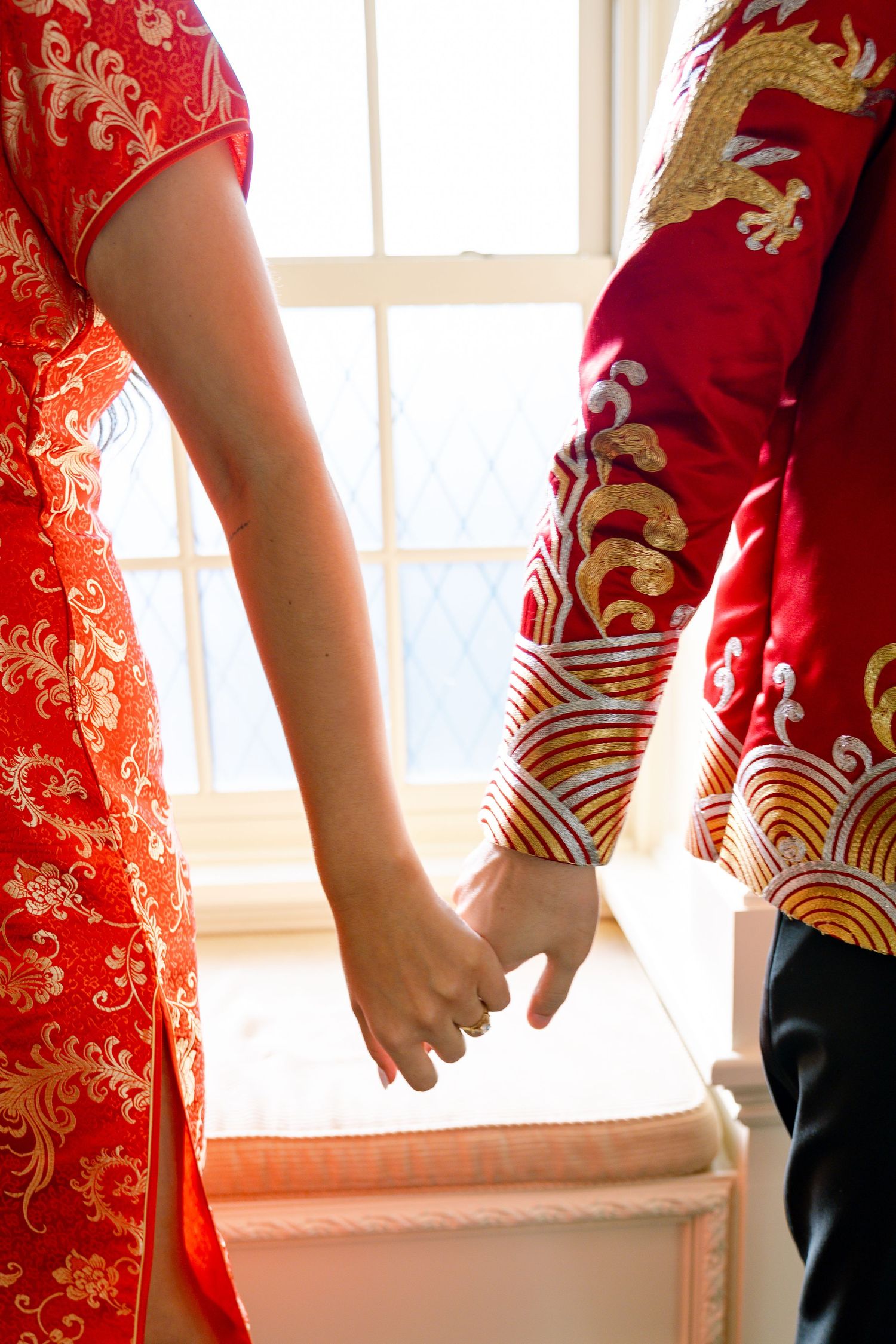 Close-up details of red and gold traditional Chinese qipao dress pattern.