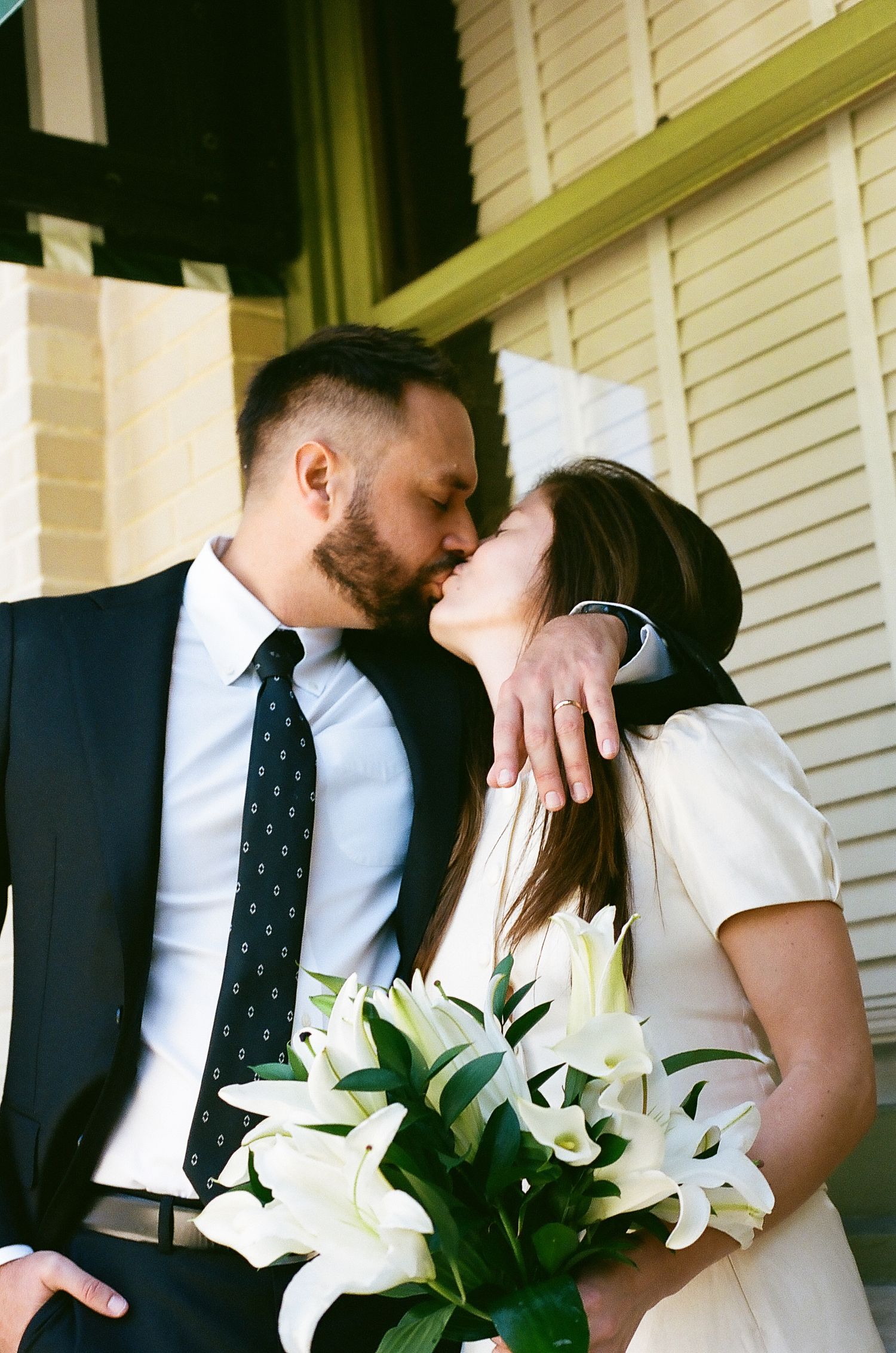 A romantic wedding couple shares intimate moments on a porch with white lilies in three sequential photos.