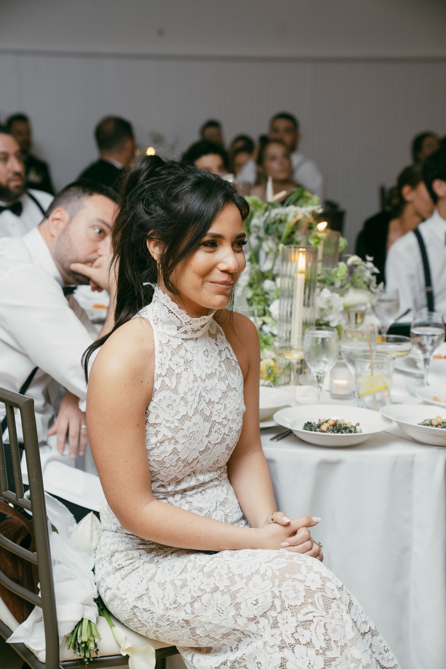 Elegant wedding reception setup with white linens, floral centerpieces and formal table settings.