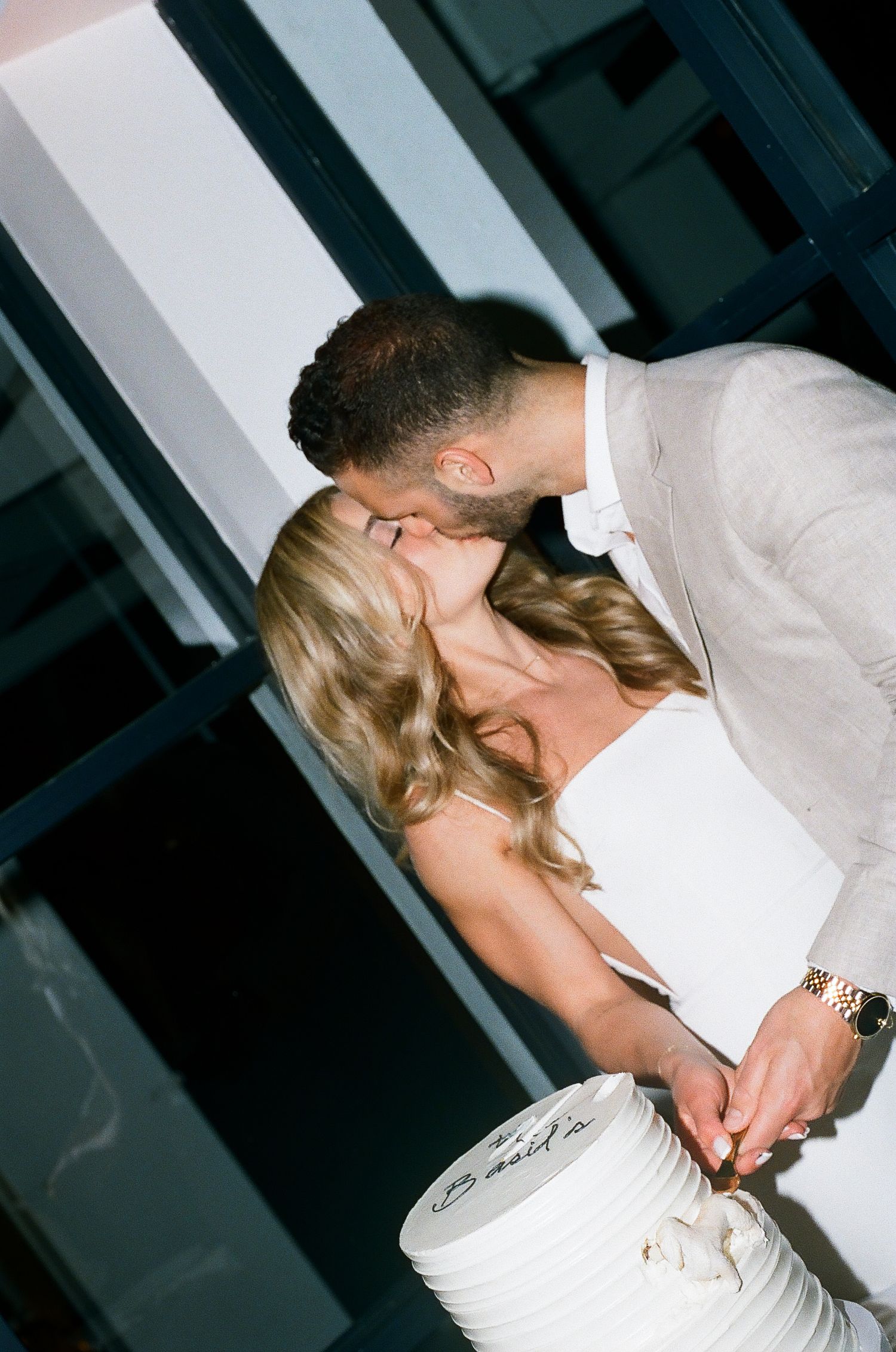 Romantic couple sharing intimate moments in a dimly lit setting.