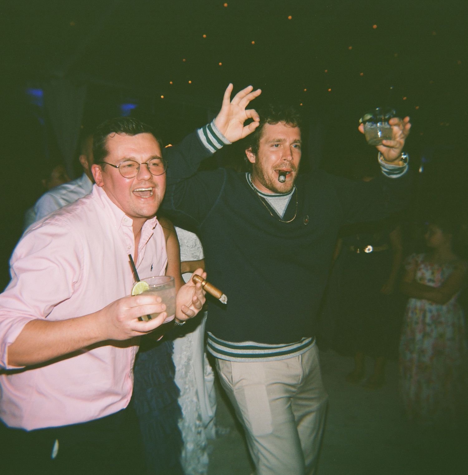 Guests dancing and celebrating at a nighttime wedding reception.