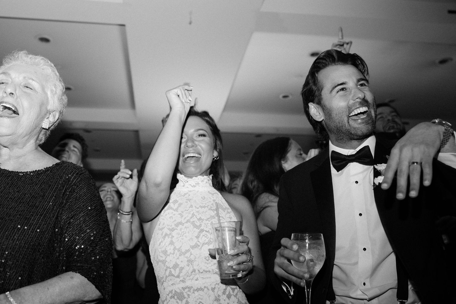Candid black and white photos capturing joyful moments during wedding reception celebrations.