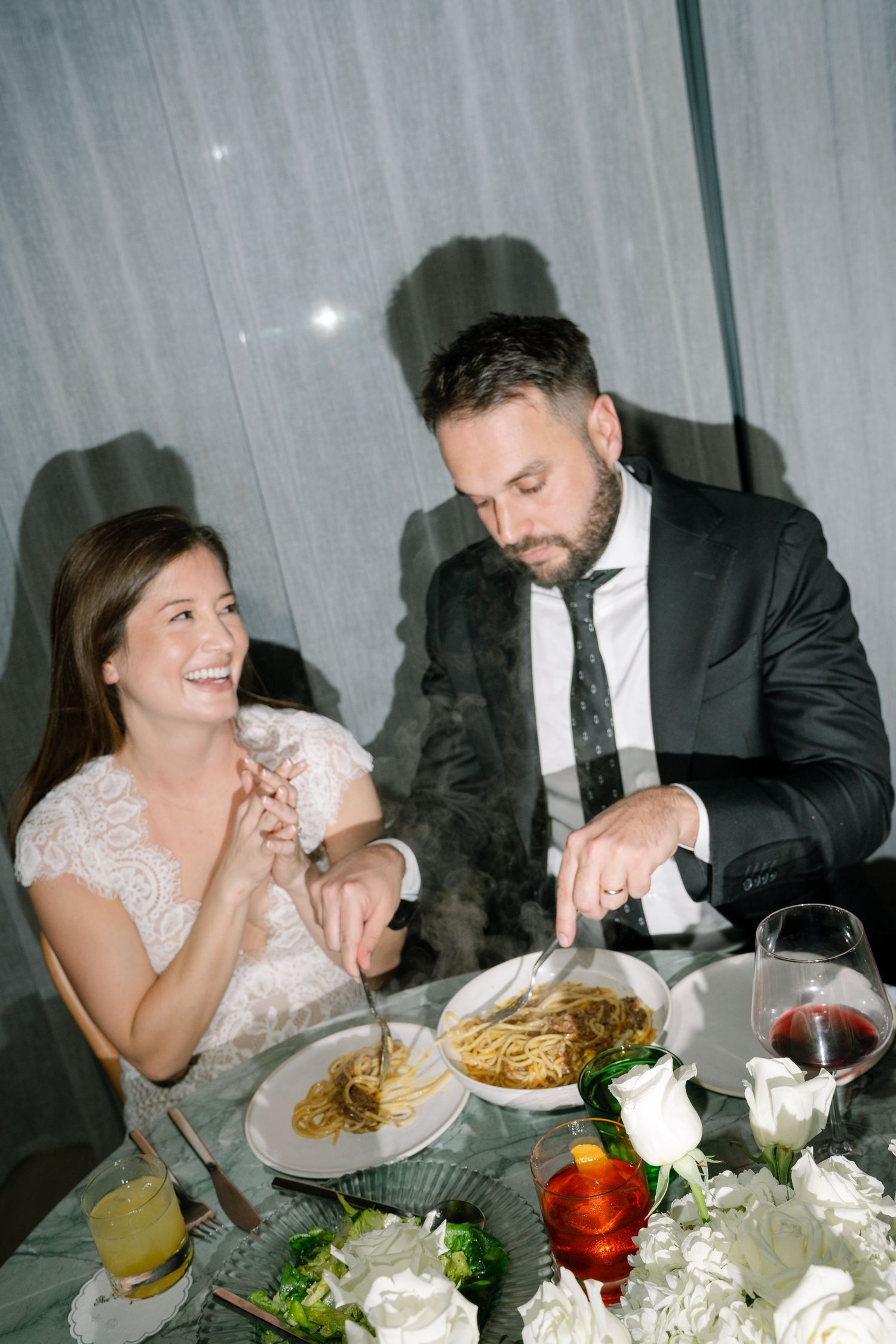 A series of candid reception dinner photos showing a couple enjoying their wedding meal at an elegant table setting.