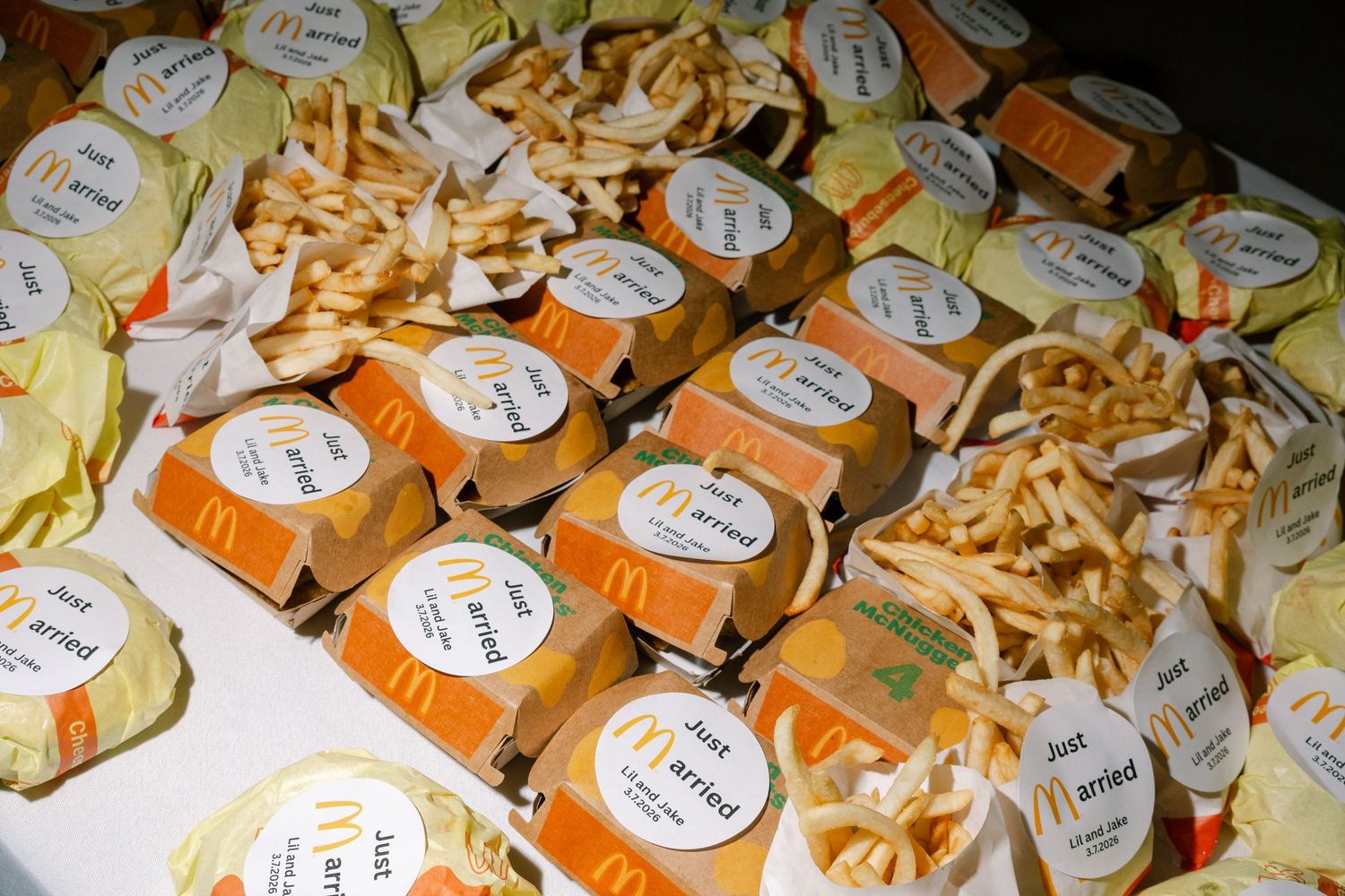 A variety of colorful cheese wedges with labels on a wooden surface.