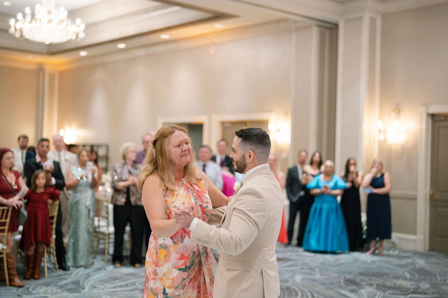 Wedding reception dance captured in an elegant ballroom setting.