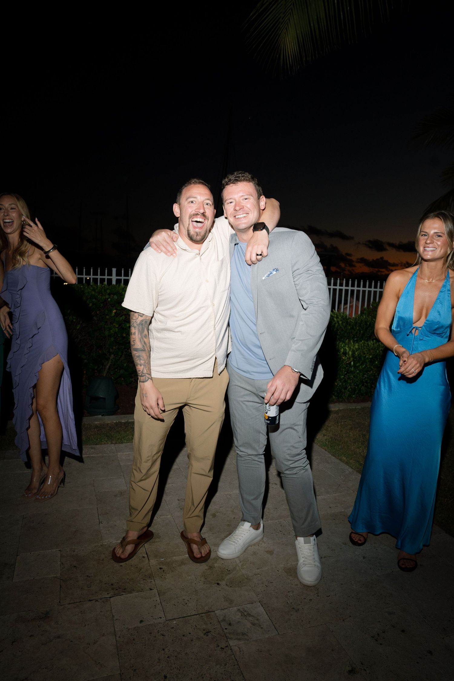 Wedding guests enjoying themselves at a nighttime outdoor celebration.