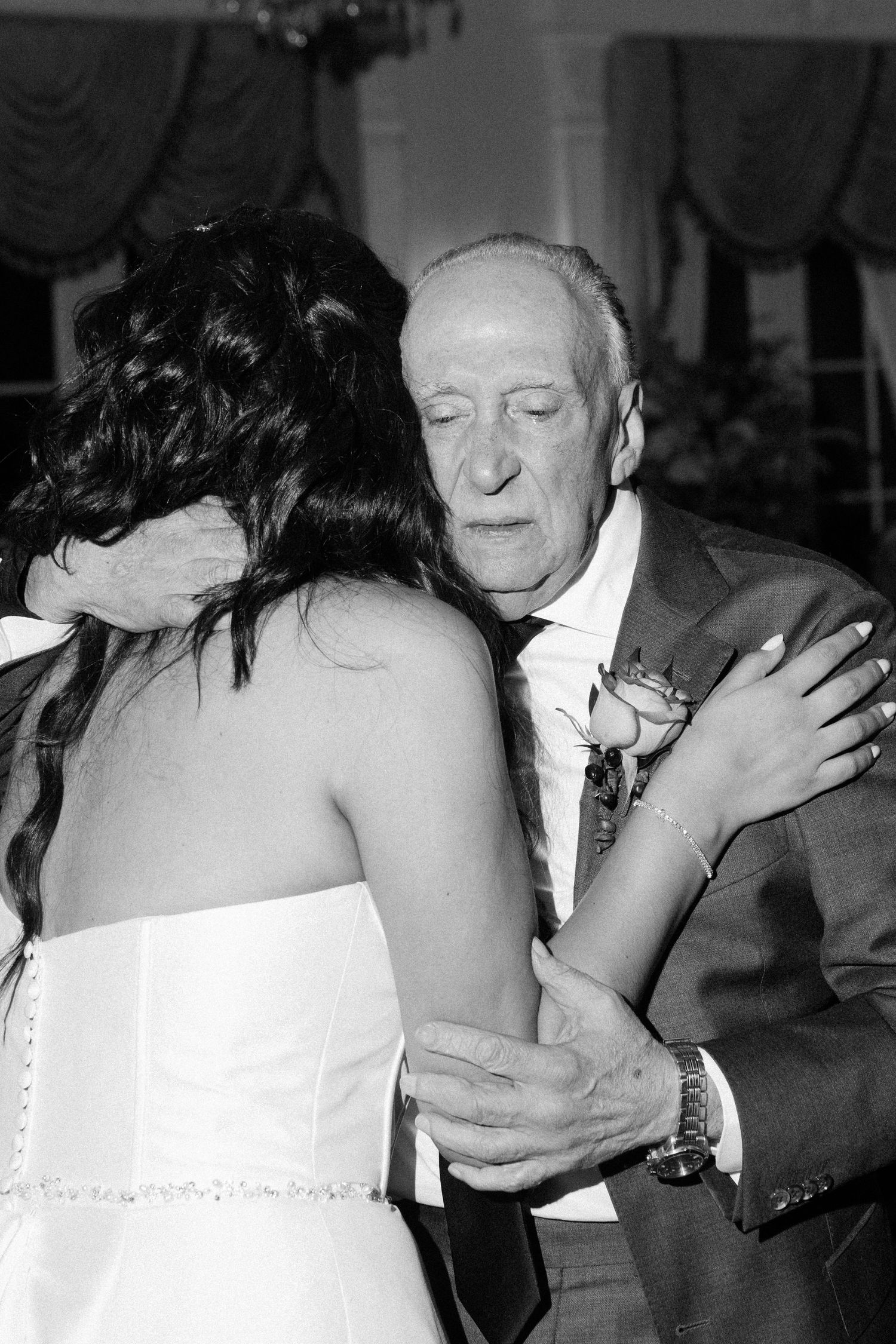 Black and white photo series capturing emotional embraces at a wedding celebration.