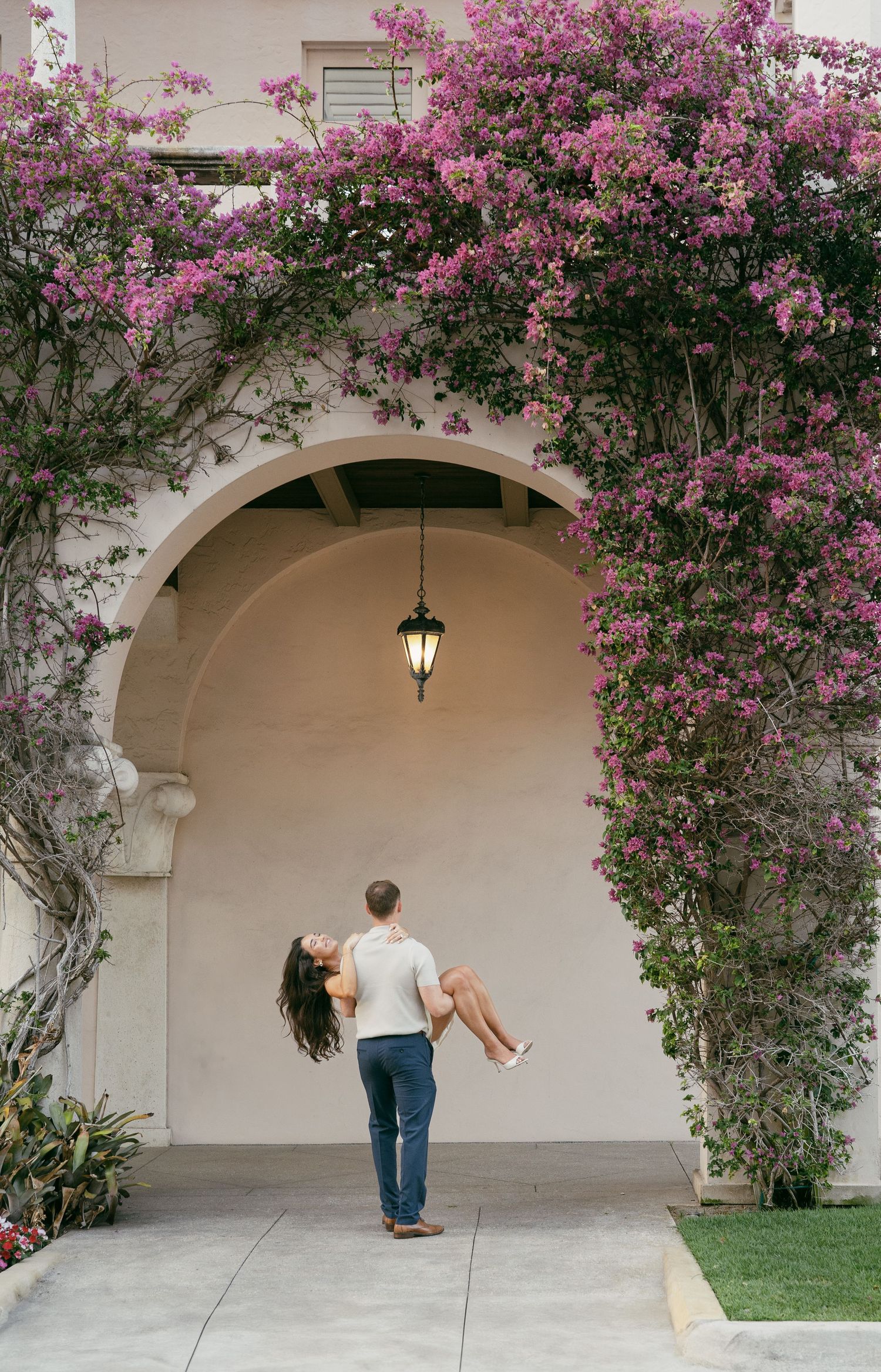Flower-covered archway with cascading pink blossoms provides a romantic backdrop for a series of progressive images.