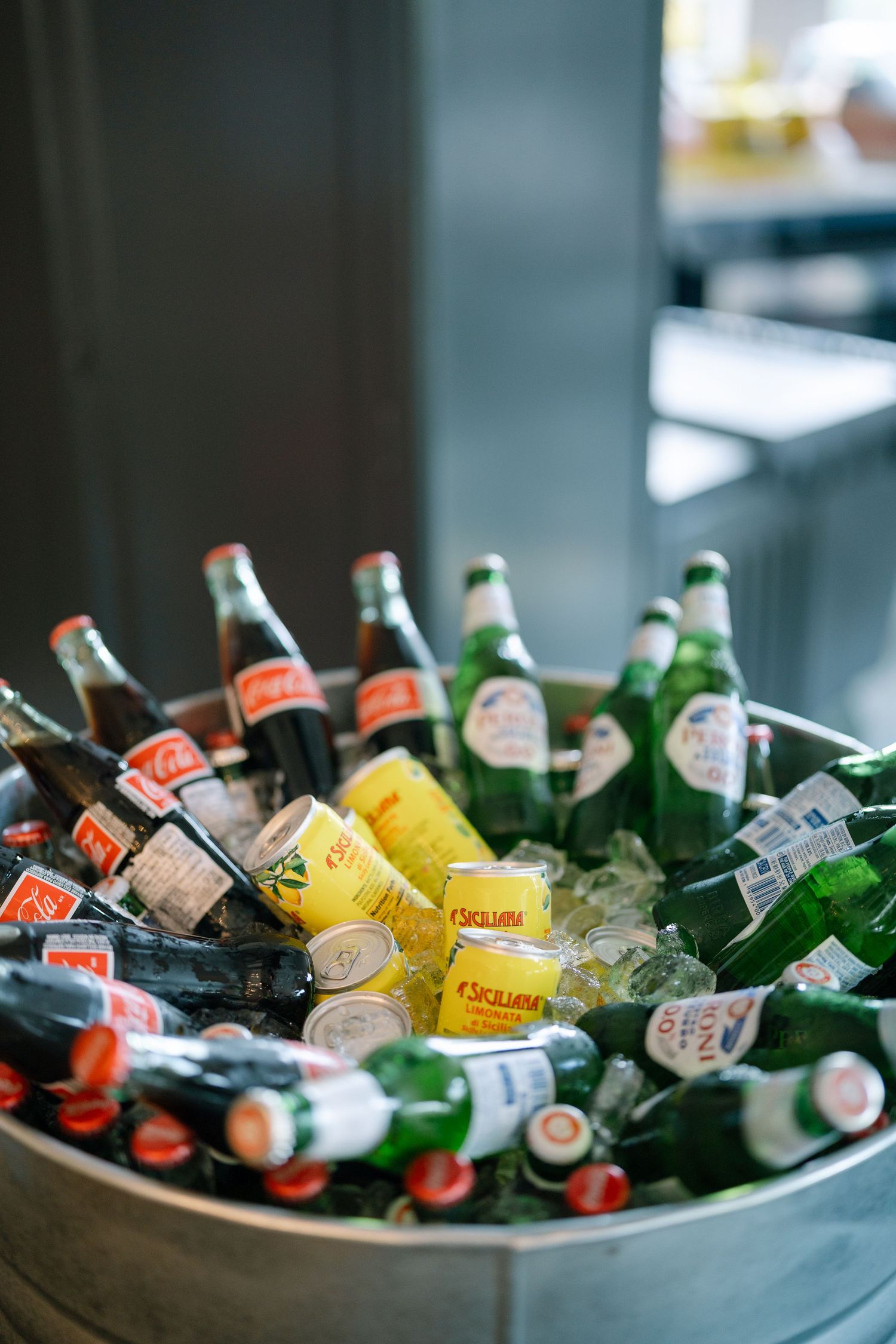 Assorted beer and beverages chilling in ice at a celebration.