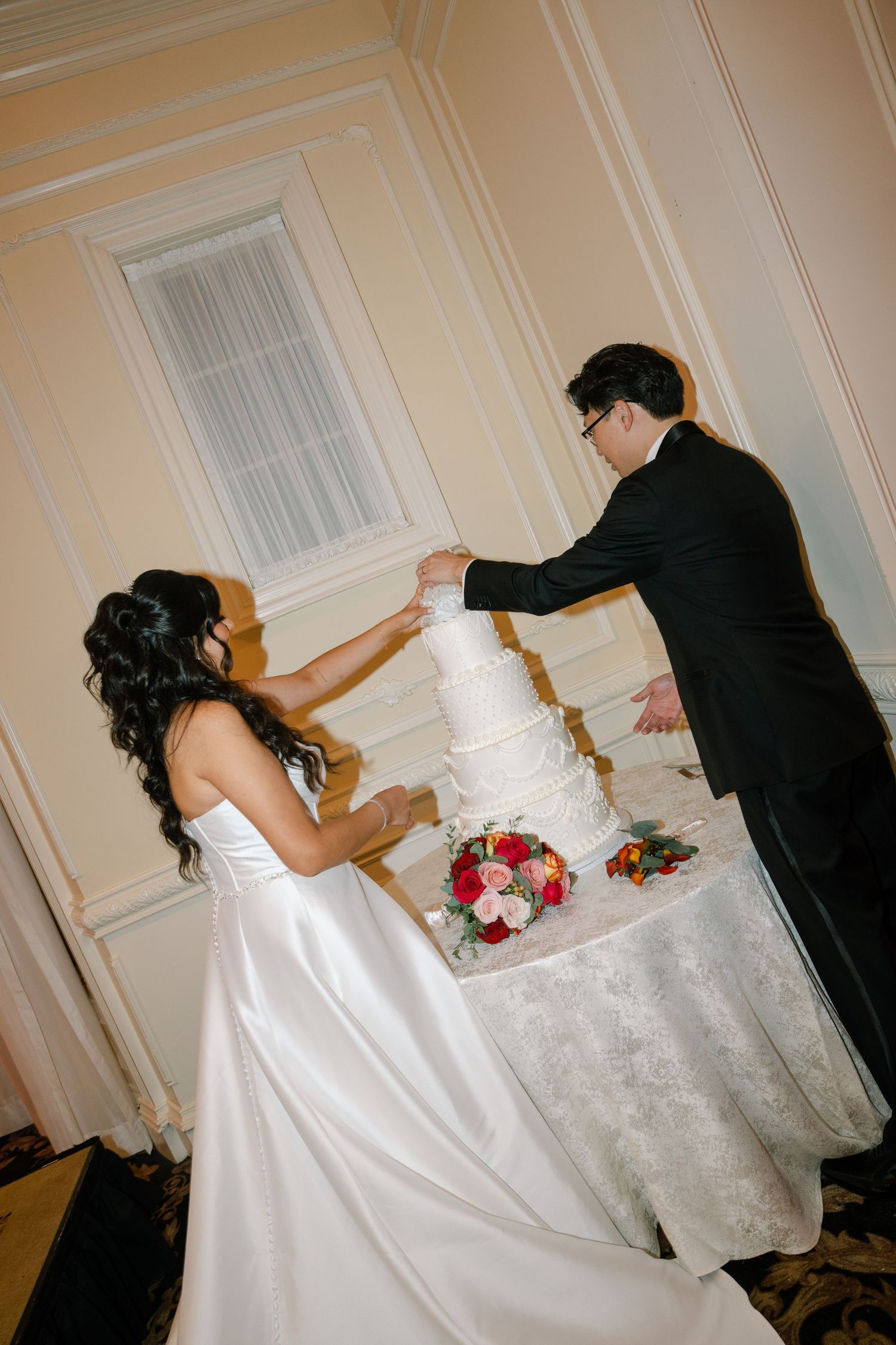 A series of photos showing a white wedding dress being adjusted and arranged at a formal event.