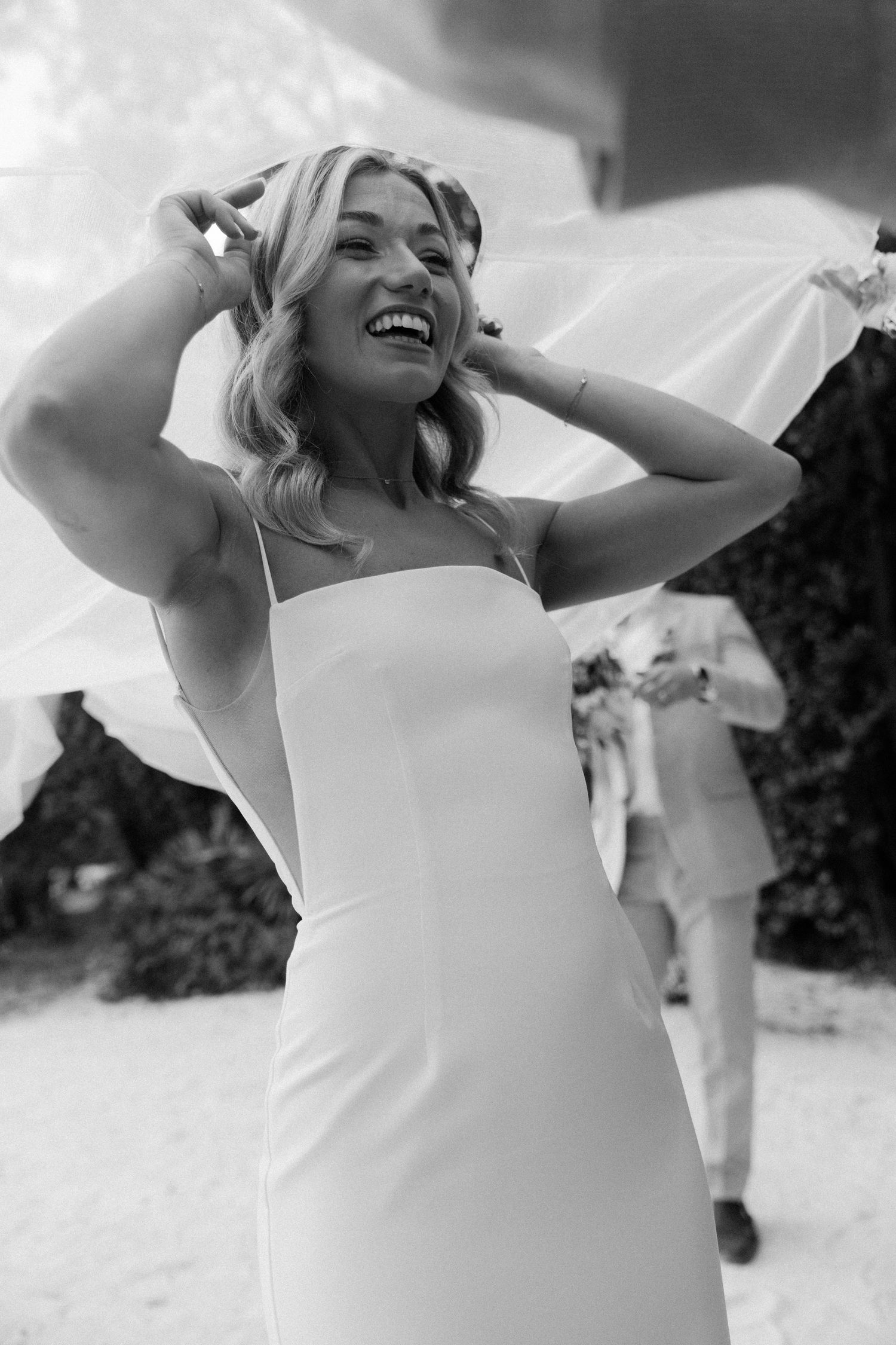 Joyful moments captured in black and white at a beach wedding celebration.