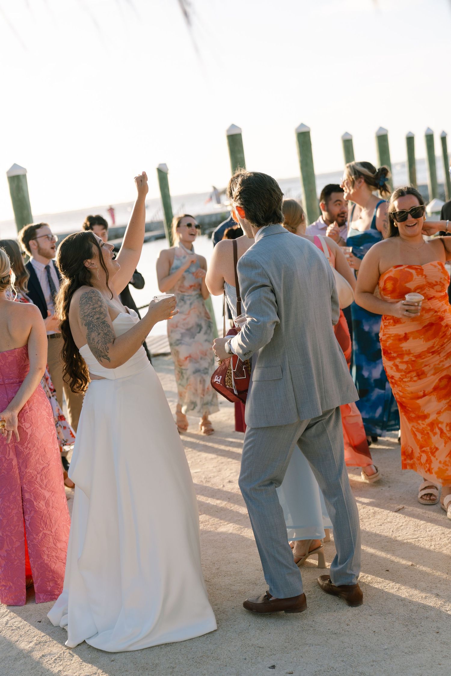 A bride and groom dancing together at their wedding ceremony, surrounded by their guests.