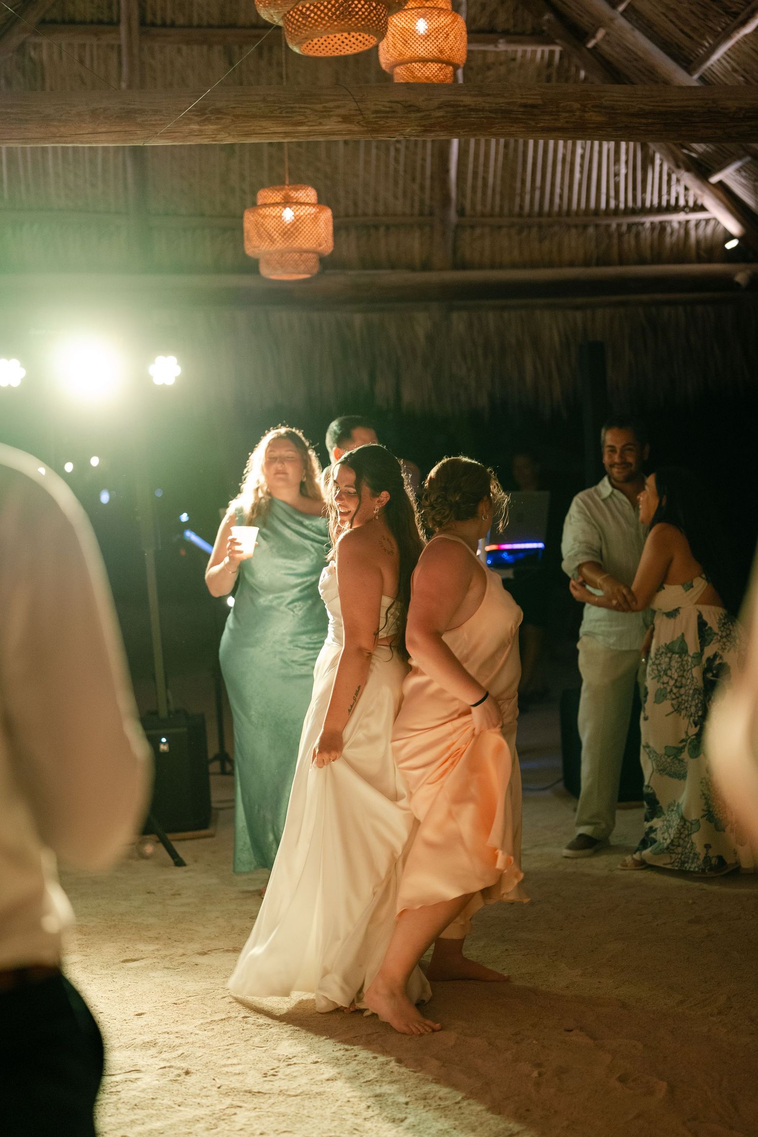 An image of a group of people, likely at a wedding reception, dancing and celebrating together.