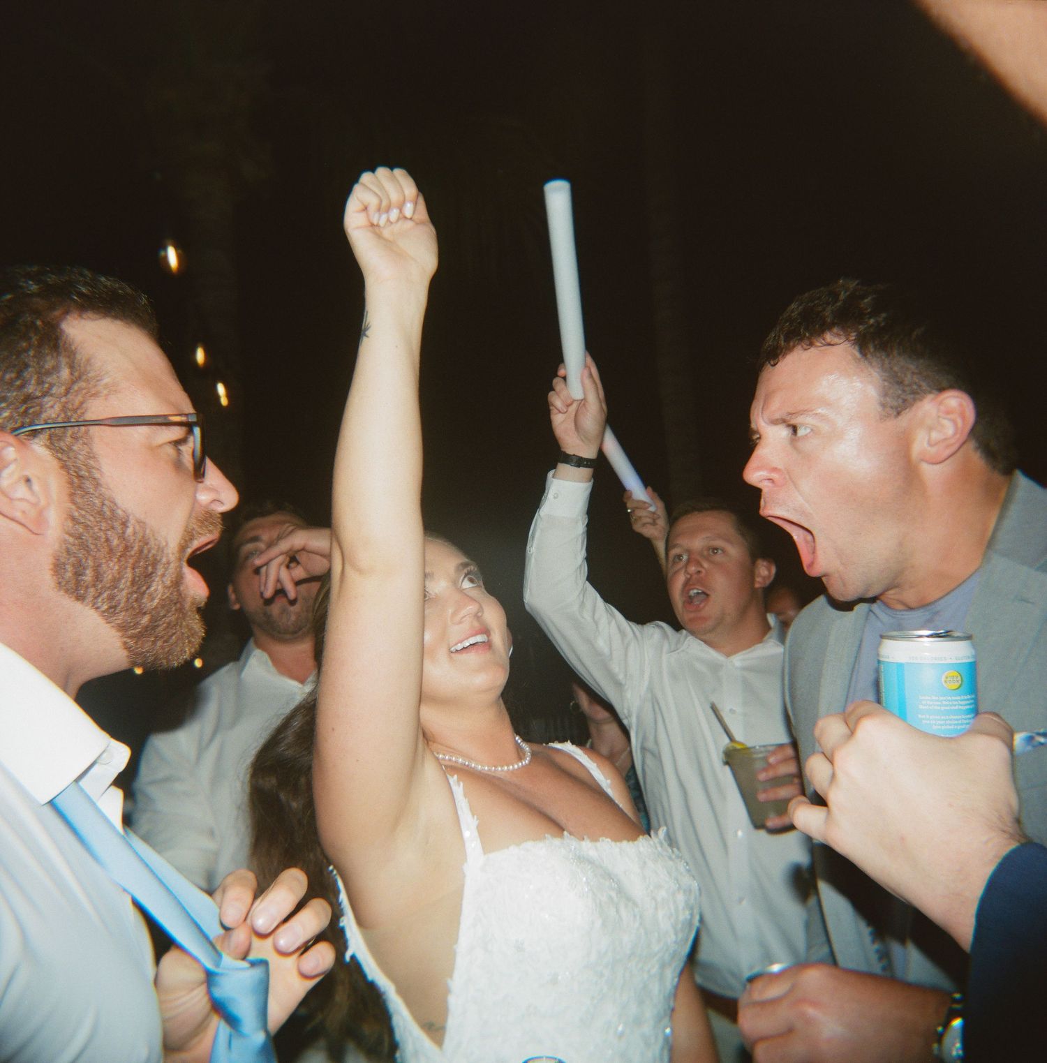 Wedding reception party with guests dancing and celebrating on the dance floor.