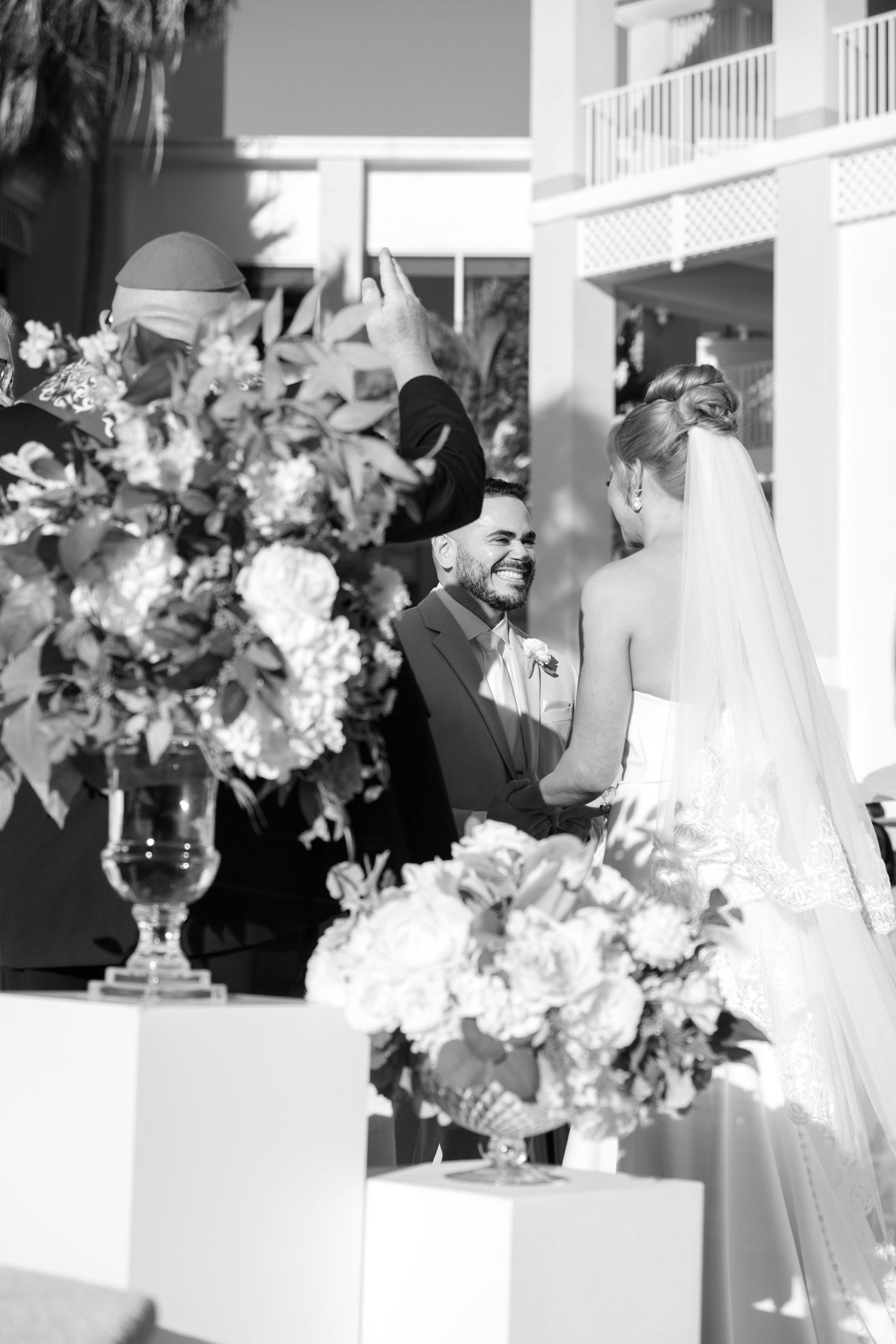 Black and white wedding reception photos with floral centerpieces and elegant table settings.