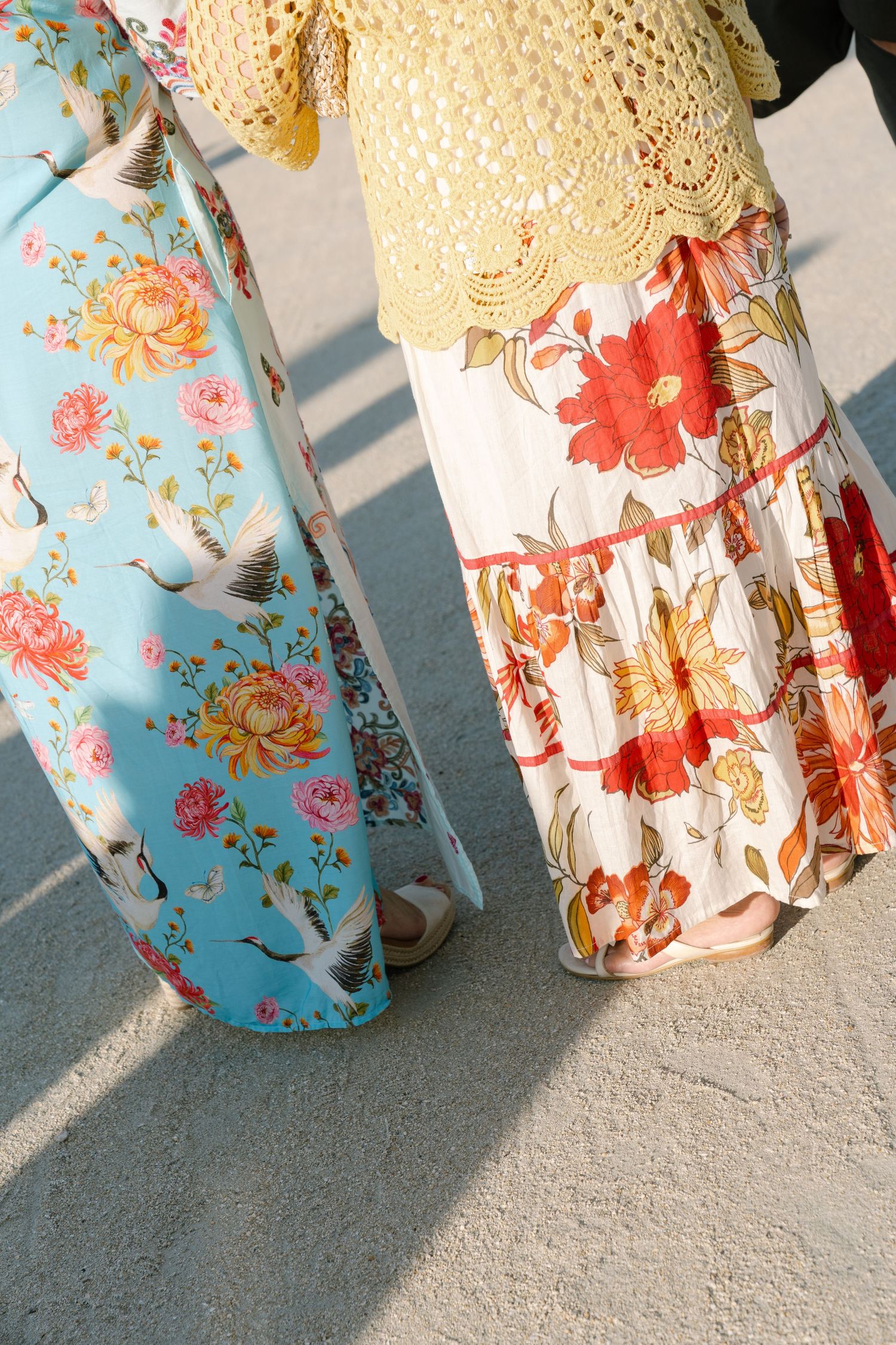 Close-up of floral robes with delicate lace trim casting shadows in sunlight.