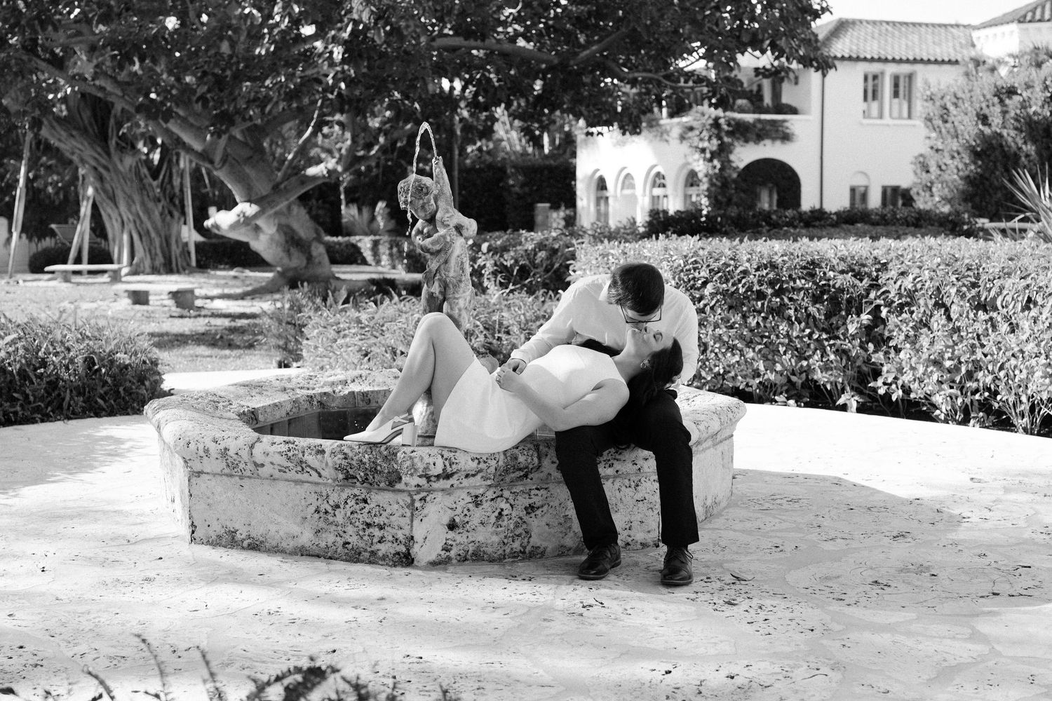 A series of black and white photographs showing people sitting and relaxing on stone walls in an outdoor setting.