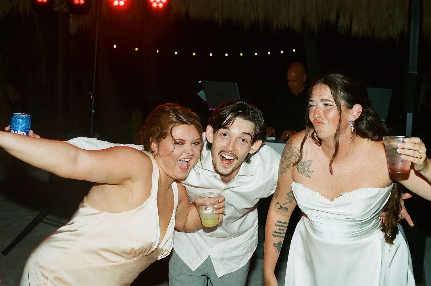 A group of people, likely friends or family, celebrating and posing together at what appears to be a party or event.