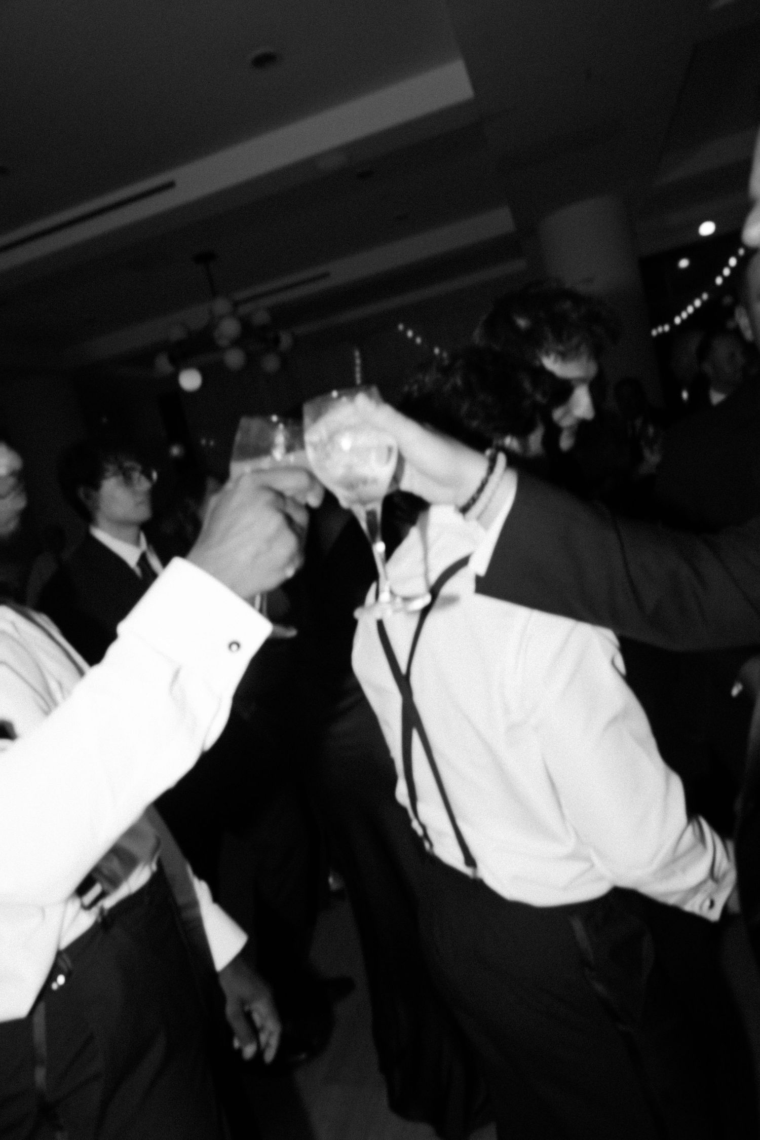 Dynamic black and white shots of wedding reception dancing and celebrations.