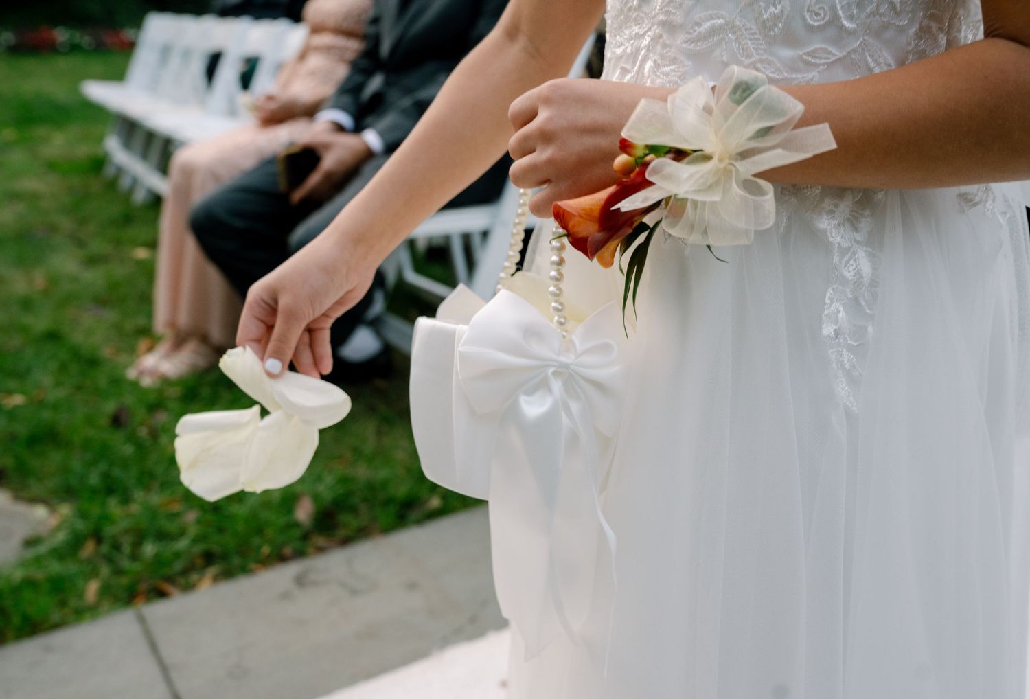 Close-up shots of hands releasing white paper lanterns into the air during an outdoor celebration.