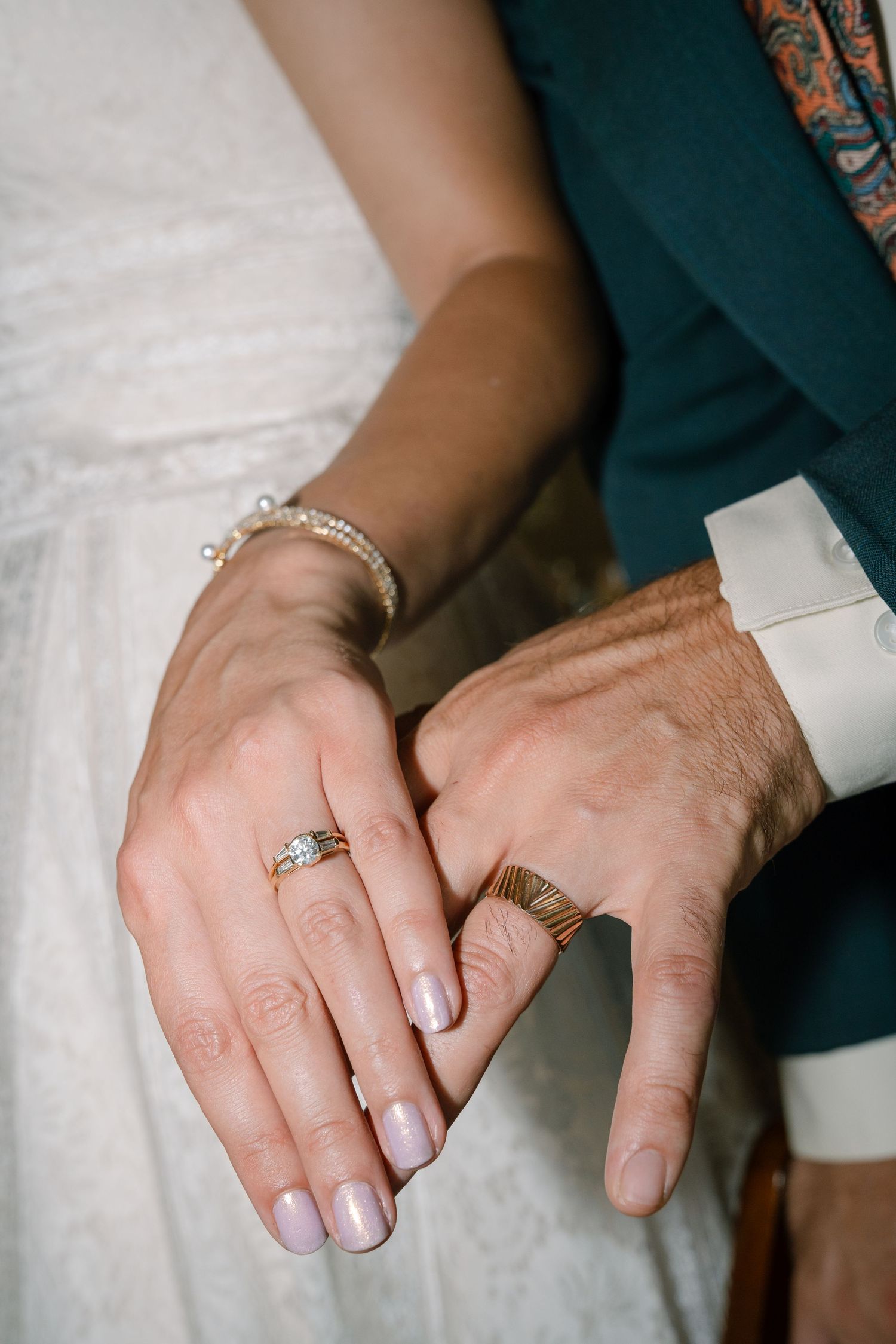 Close-up shots of hands wearing wedding rings and jewelry.