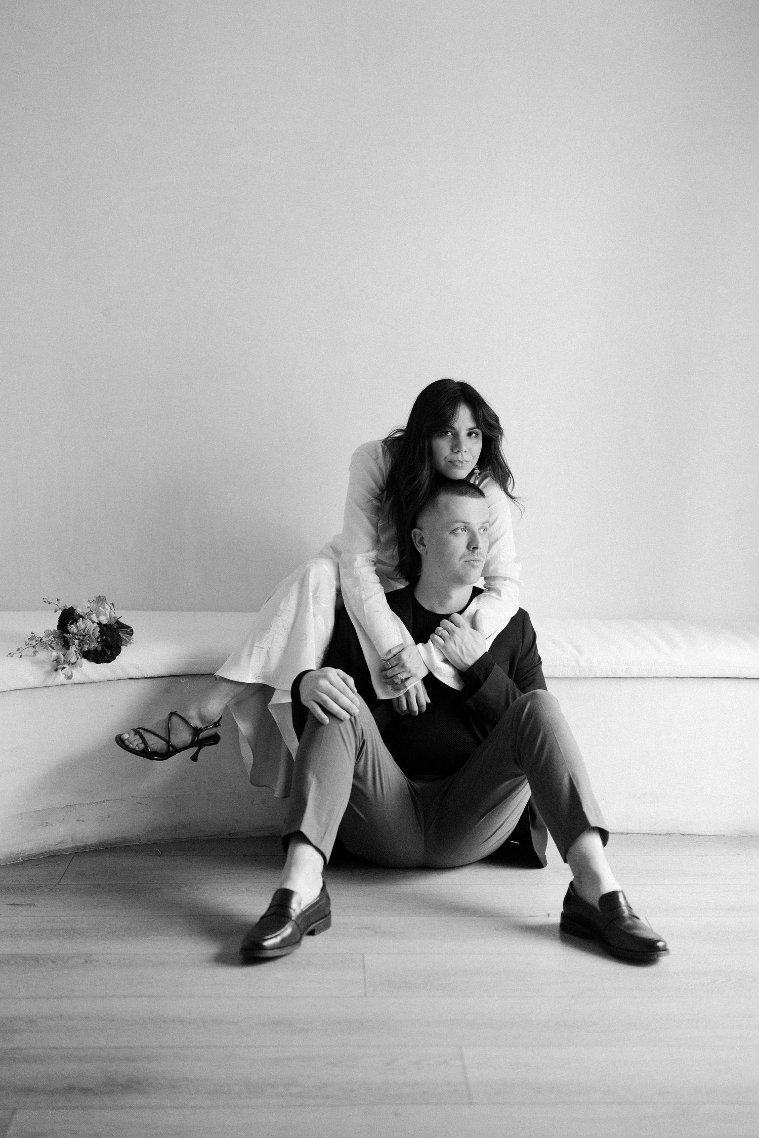 Artistic black and white photo series showing dynamic poses on a minimalist white floor.
