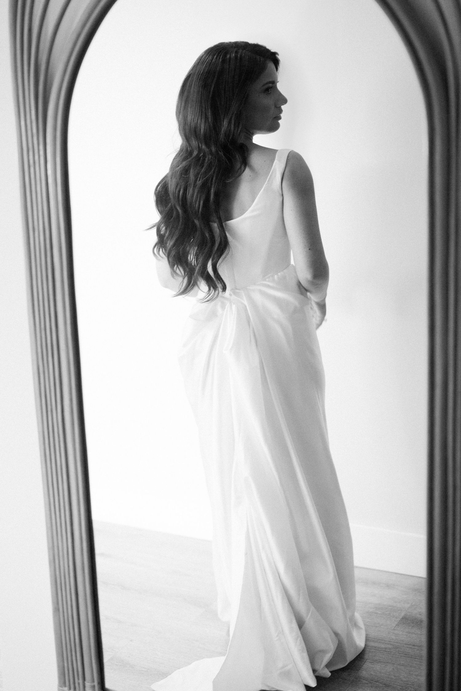 Artistic black and white series showing a figure in white against arched windows creating dramatic silhouettes.