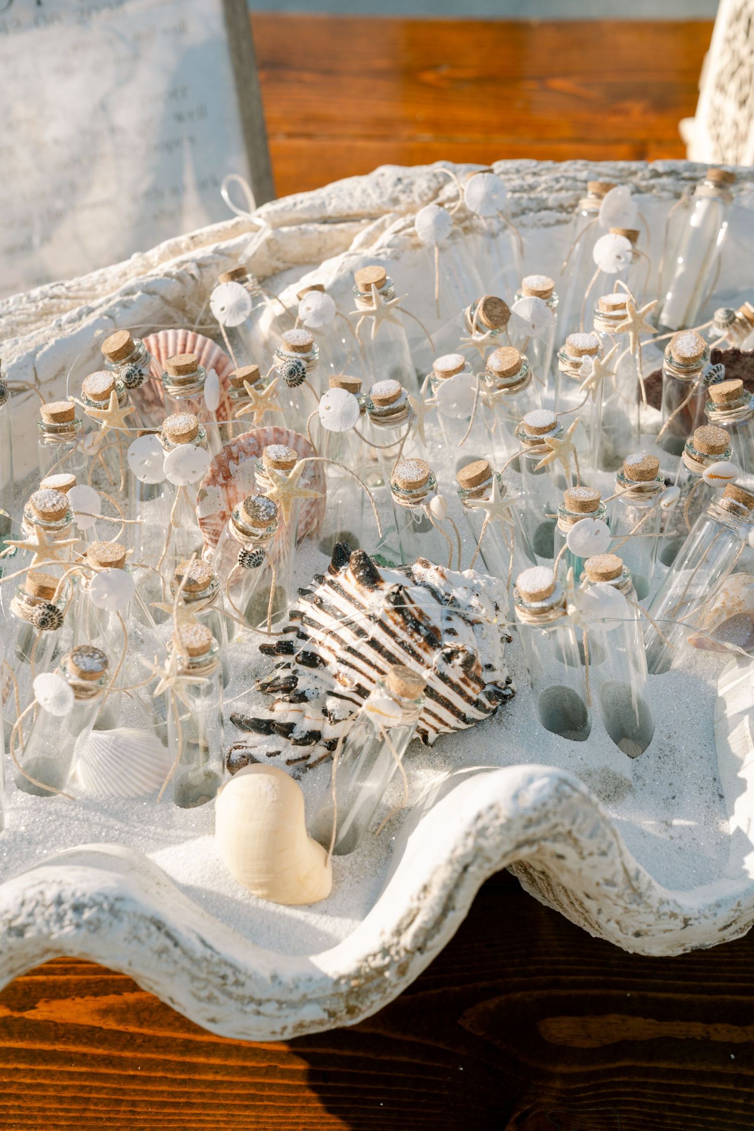 Small glass vials with cork stoppers arranged on a white lace doily display on wooden table.