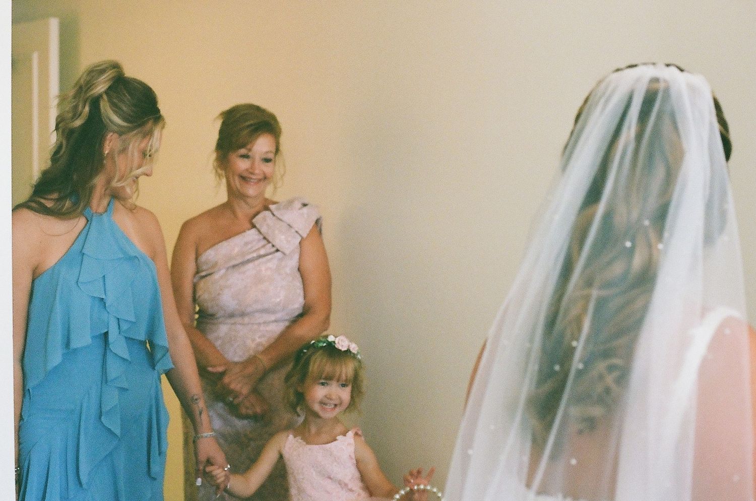 A series of wedding preparation photos showing a bride getting ready with bridesmaids in turquoise dresses and pink accents.