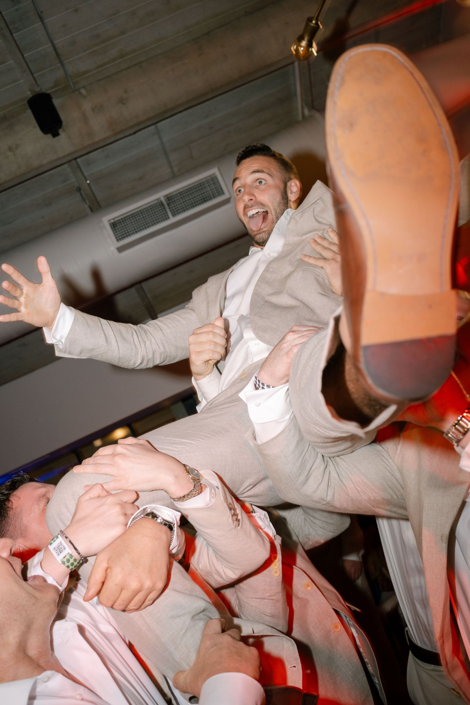Dynamic photo sequence of wedding guests dancing and celebrating in light colored attire.