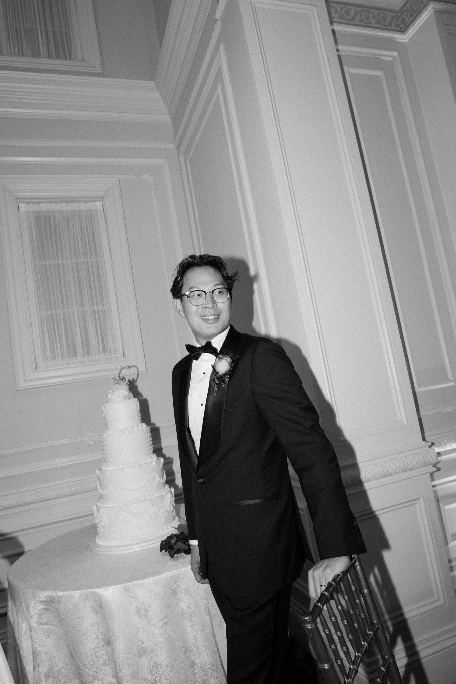 Black and white sequence showing elegant white tiered wedding cake and formal celebration.