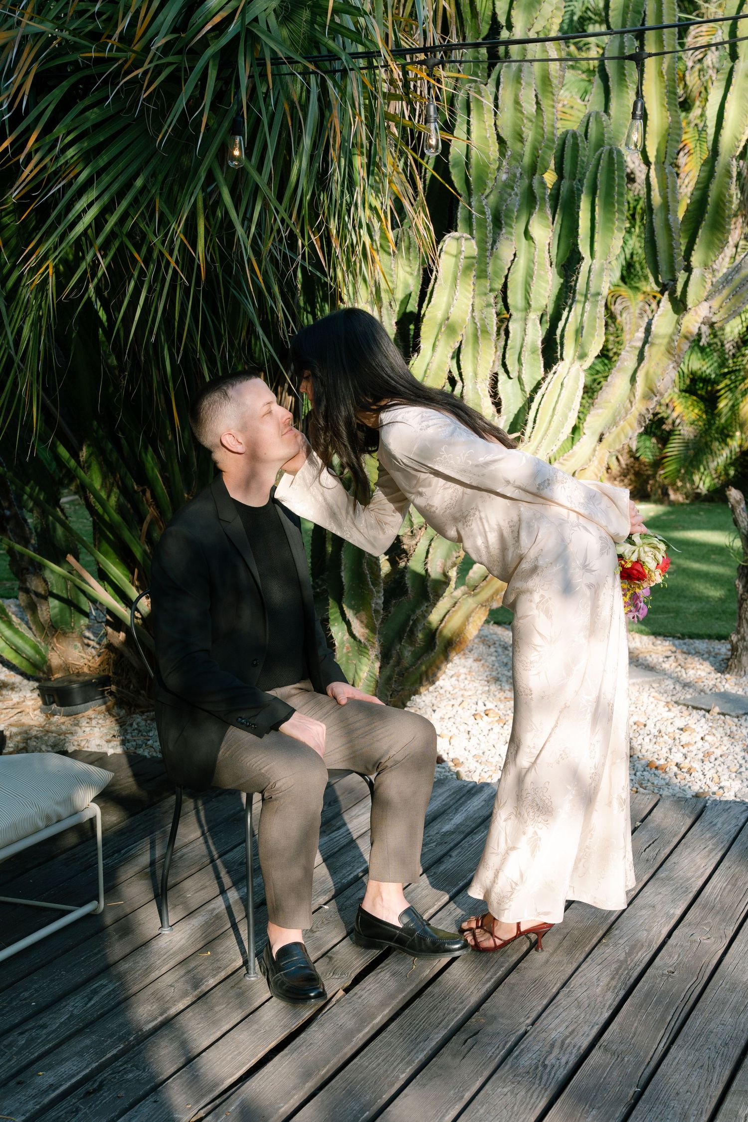 Series of romantic moments captured on wooden deck surrounded by tropical plants.