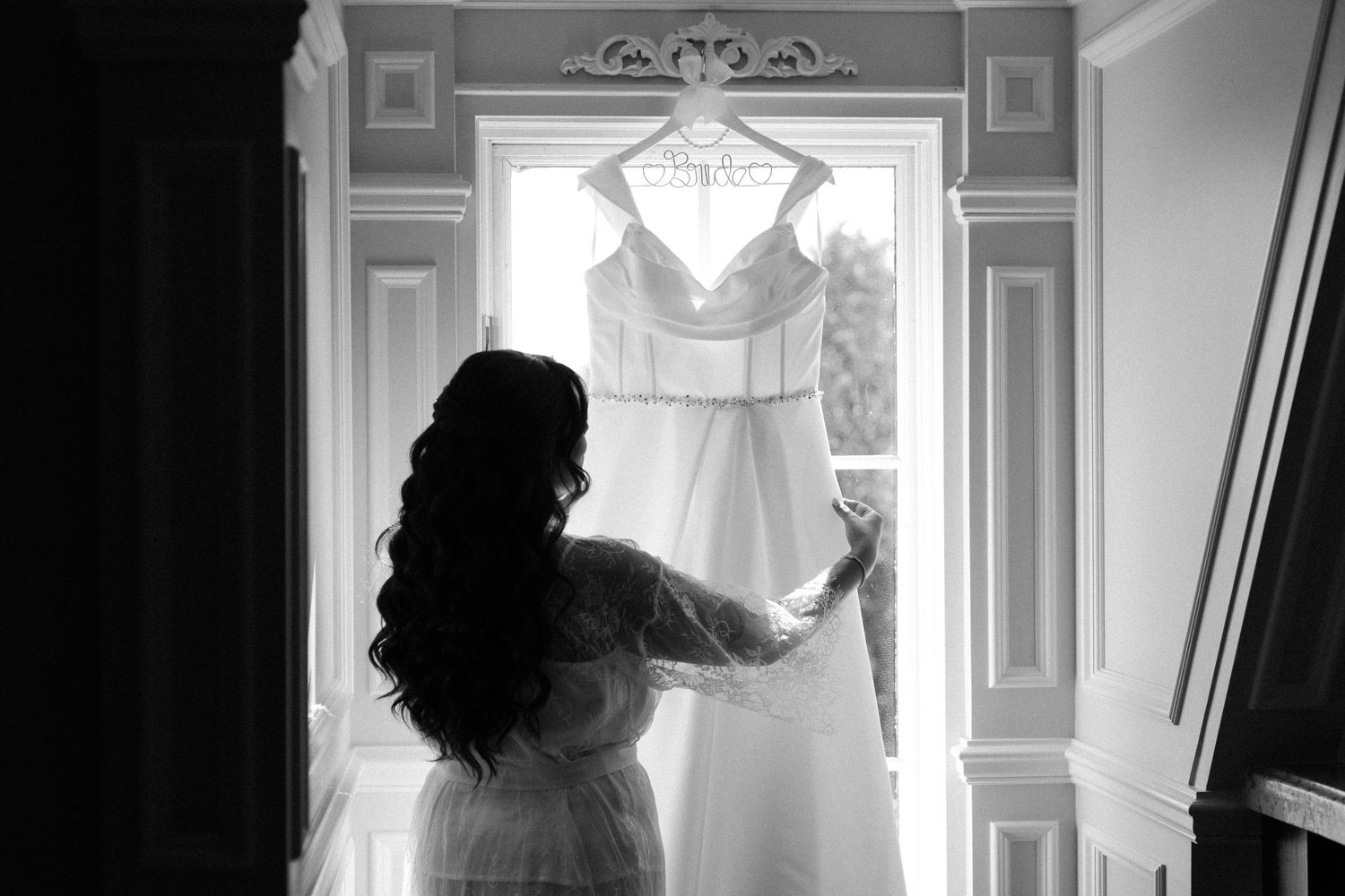 A sequence of black and white photos showing a couple's silhouettes against a bright window during an intimate moment.
