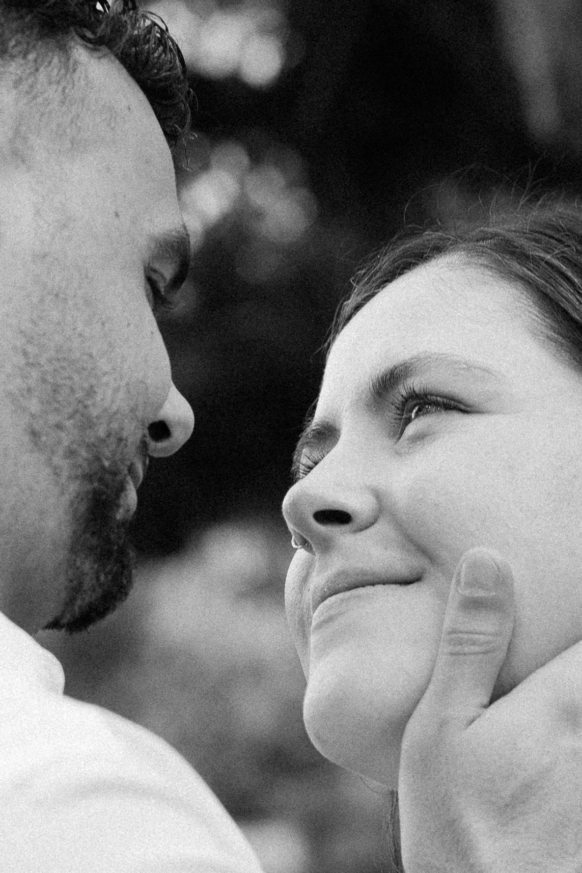 A series of black and white close-up profile shots showing an intimate moment between two people looking at each other.