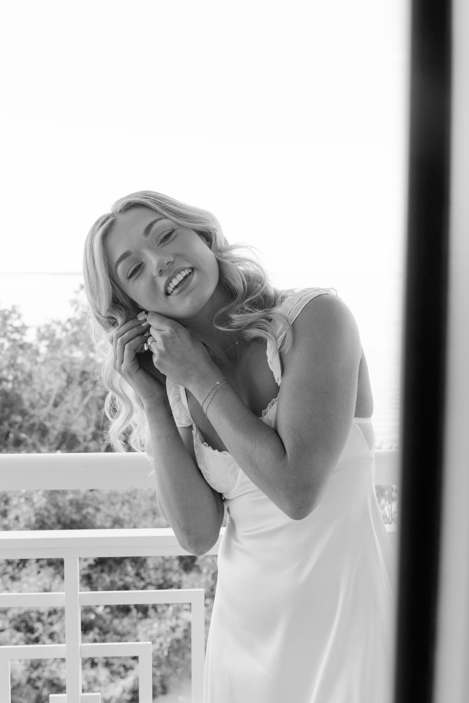 Black and white portraits showing joyful laughter in natural window light.