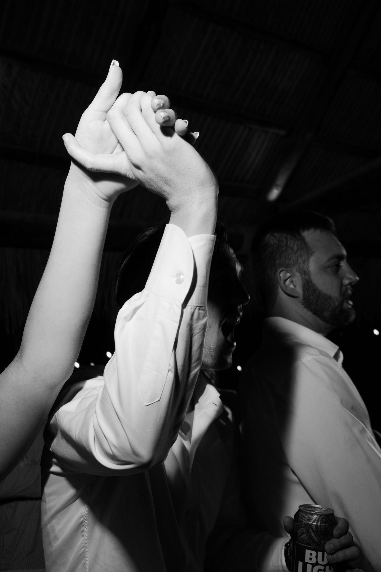 An image of a person raising their arms in a celebratory gesture on a dance floor.