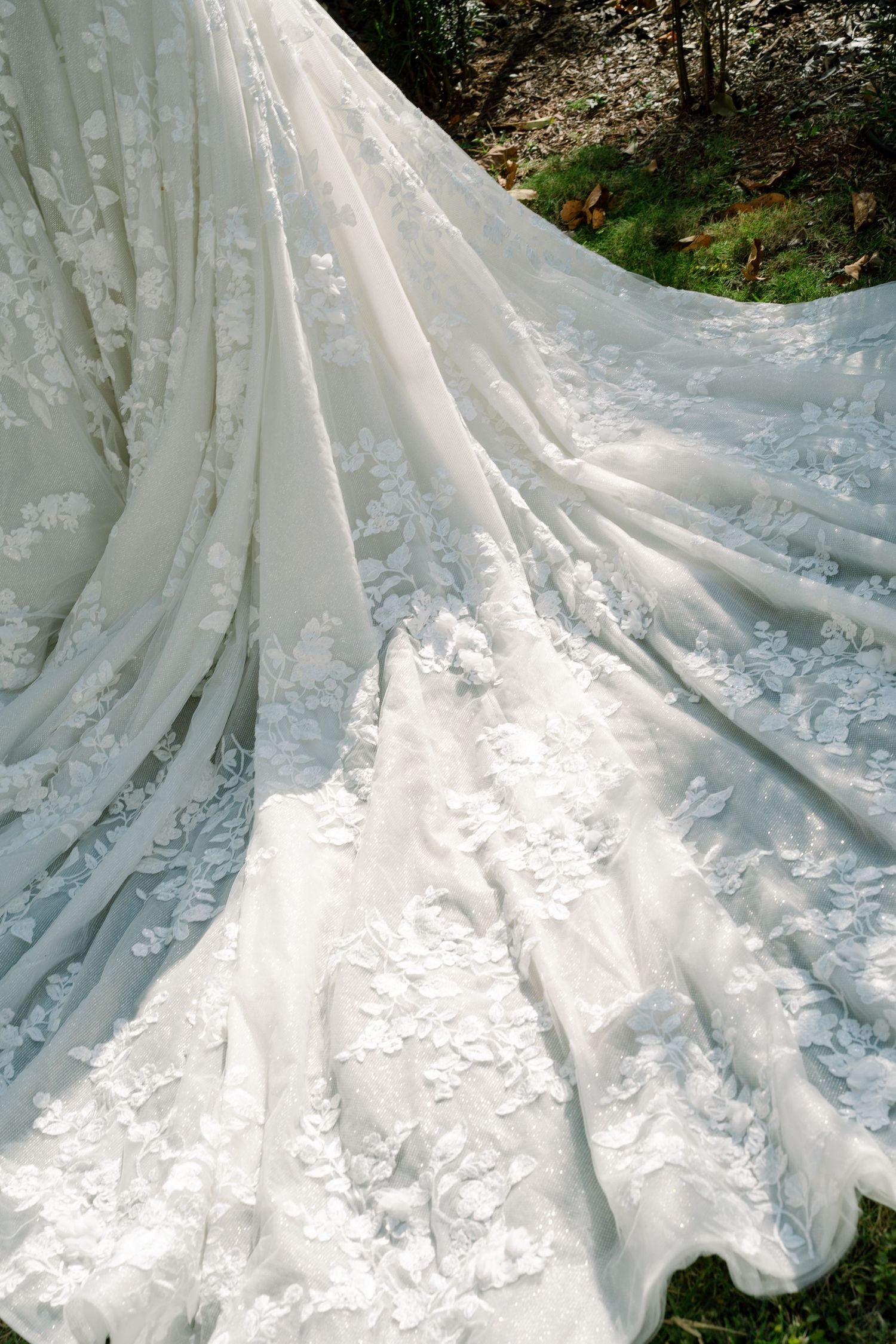 A close-up view of a frozen waterfall cascading over a rocky surface in a forested area.