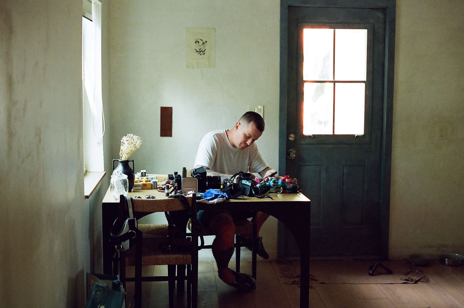 A series of connected interior photographs showing sparse rooms with windows and minimal furnishings in muted tones.