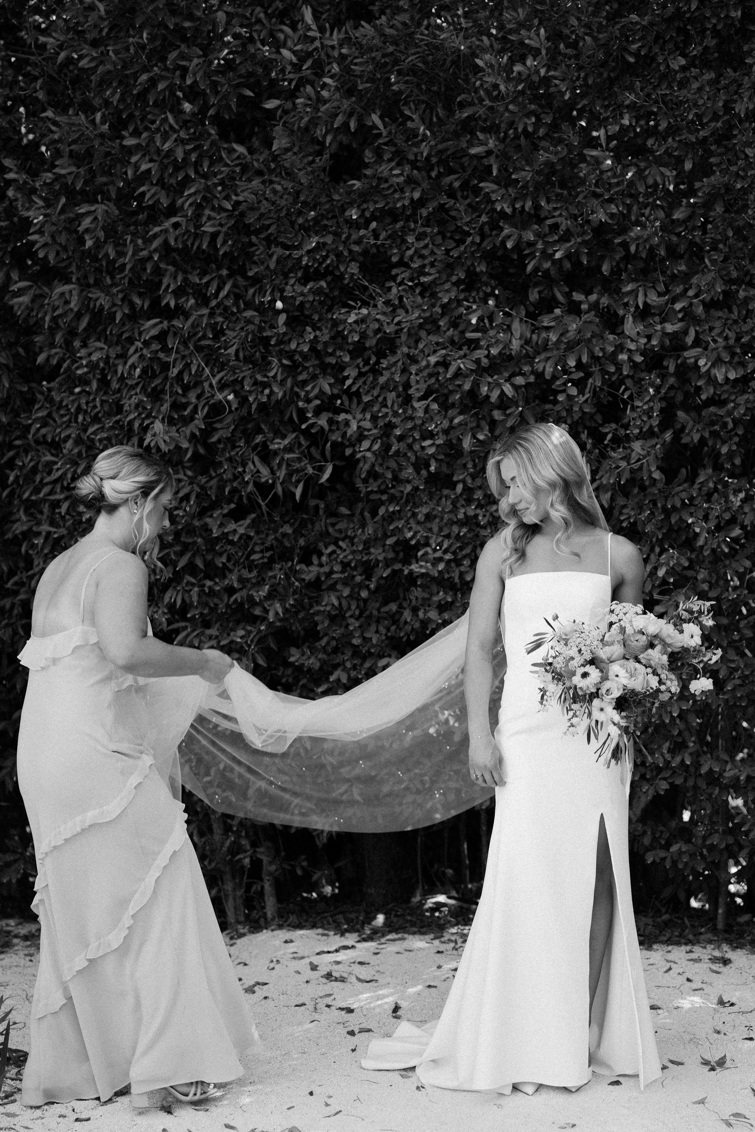 Sequence showing flowing white dress movement against dark foliage background.