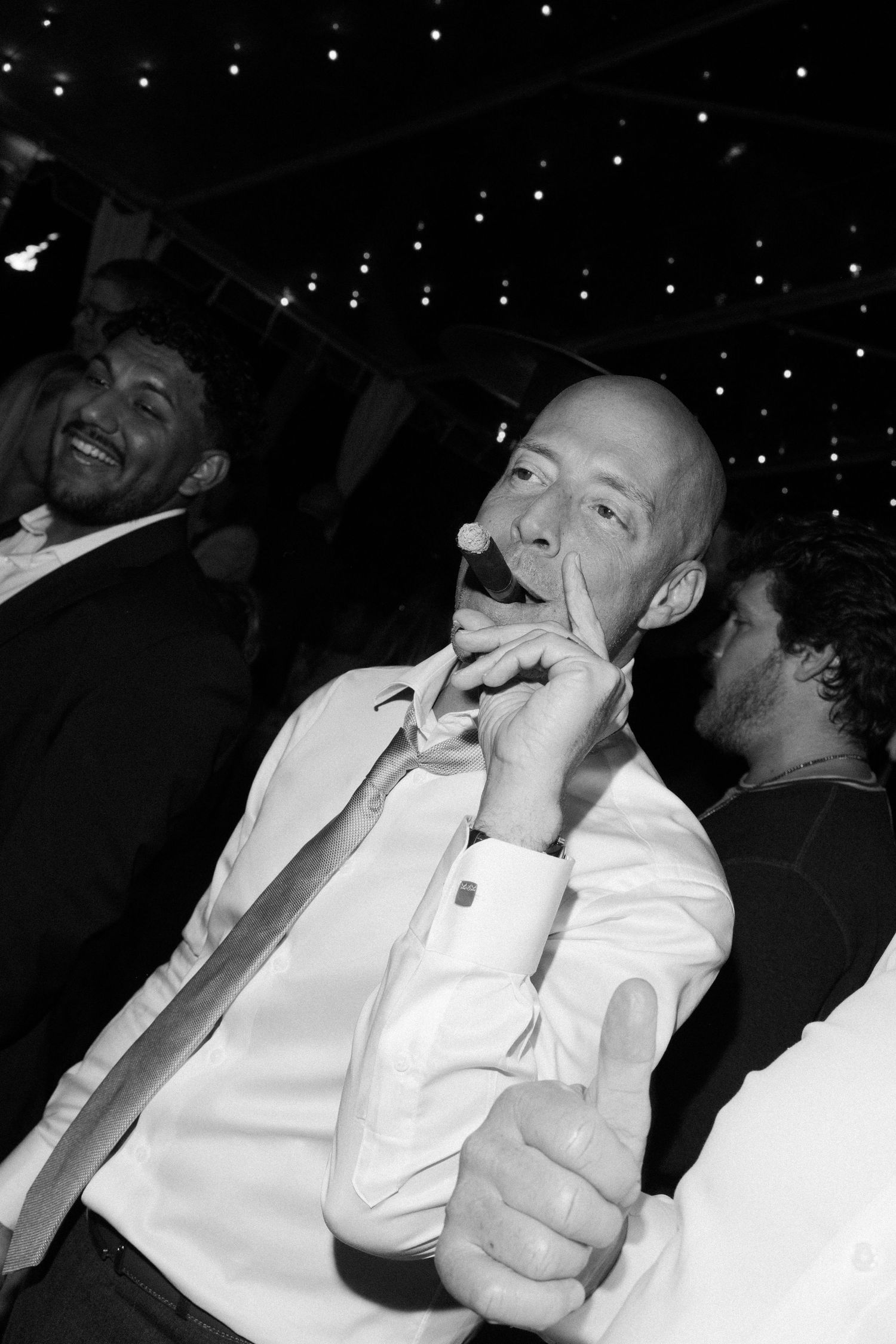 Black and white candid party photos showing guests laughing and enjoying themselves.