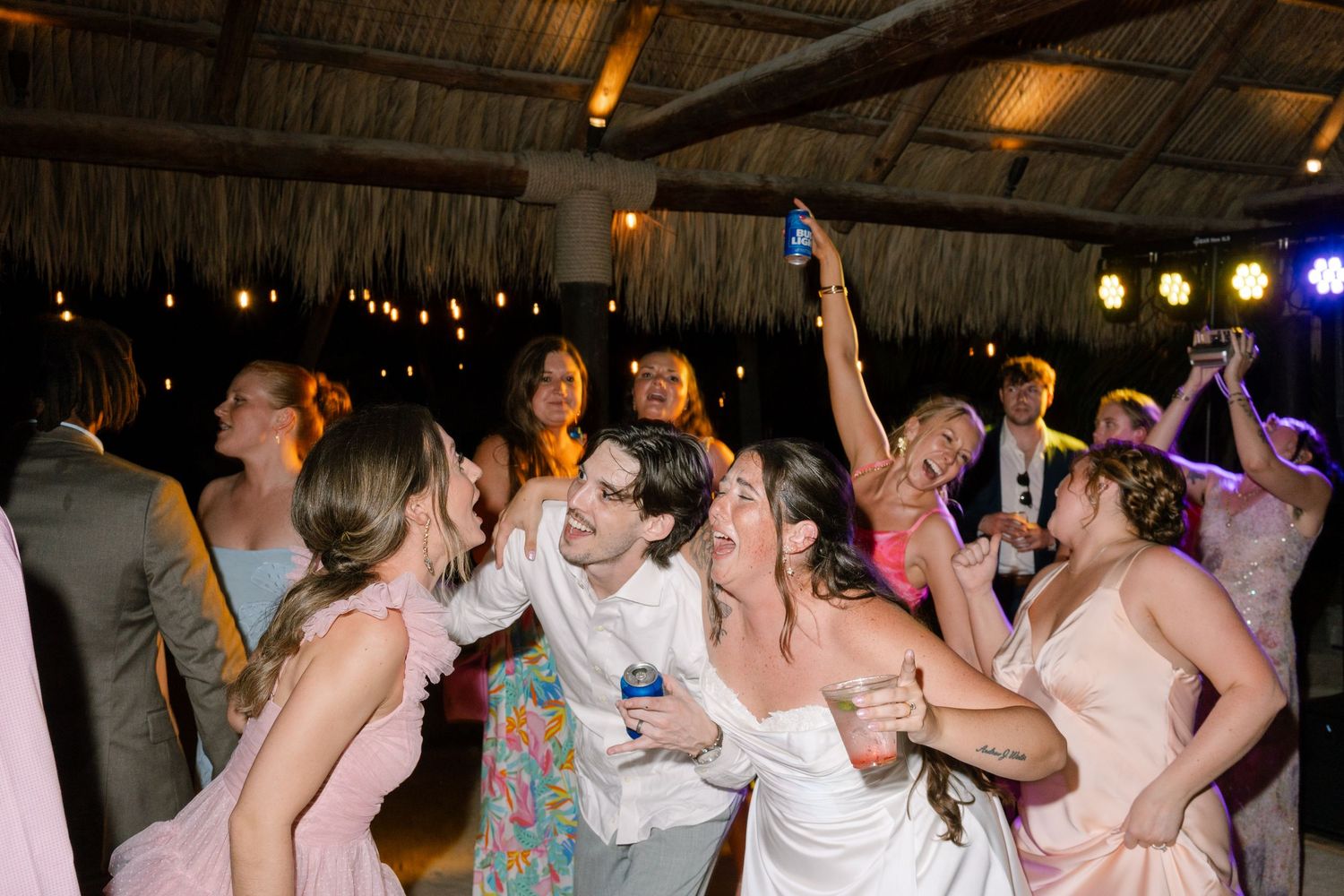 A lively dance party with a group of people celebrating and dancing together in a festive atmosphere.