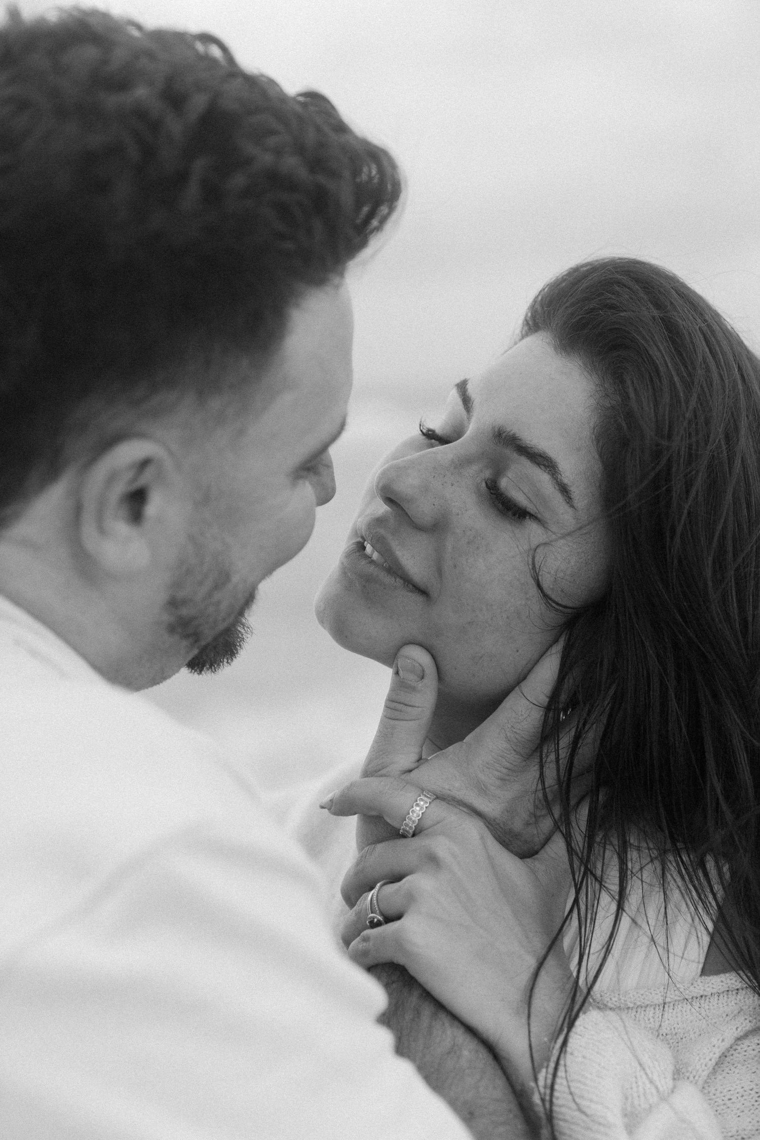 Black and white romantic sequence showing a tender intimate moment between two people in close proximity.