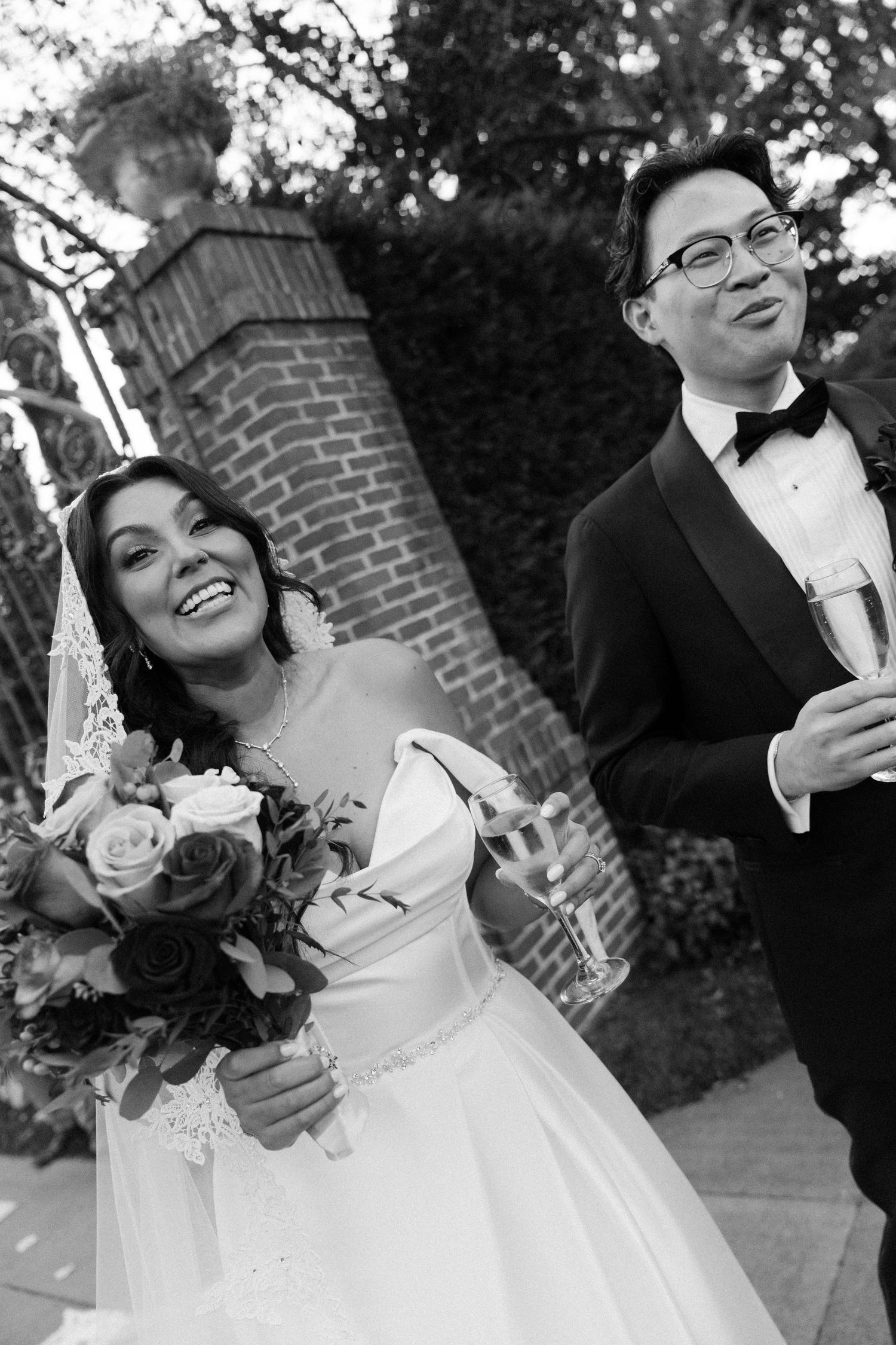 Wedding couple sharing joyful moments and laughter during outdoor photo session.