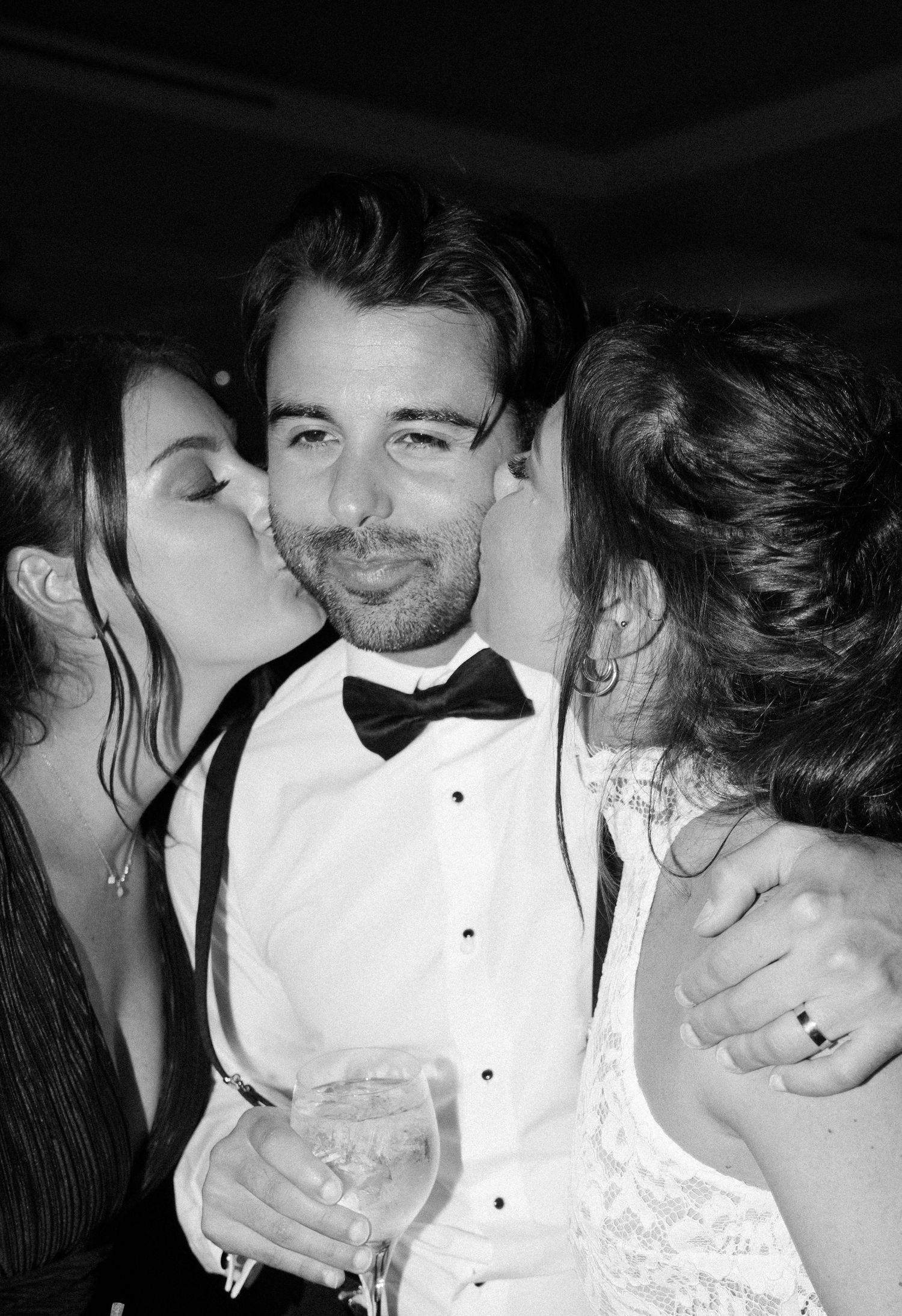 A celebratory moment captured at a formal event with guests in black tie attire.